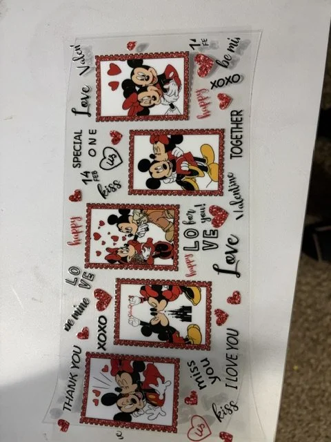 Decorative sheet with Mickey Mouse images surrounded by red hearts and love-themed words and phrases such as "Happy", "Love", "XOXO", "Thank You", and "Kiss".