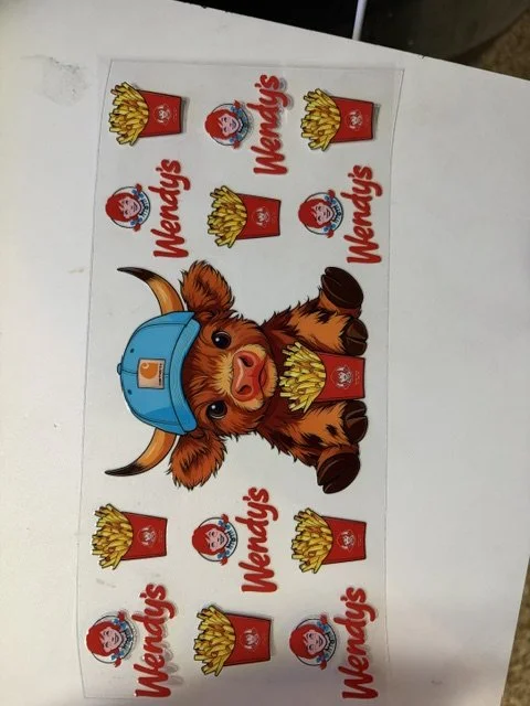 Wendy's promotional sticker sheet featuring the dog from Wendy's logo wearing a blue cap, surrounded by multiple images of Wendy's french fries and Wendy's logo, all arranged in a pattern on a white background.