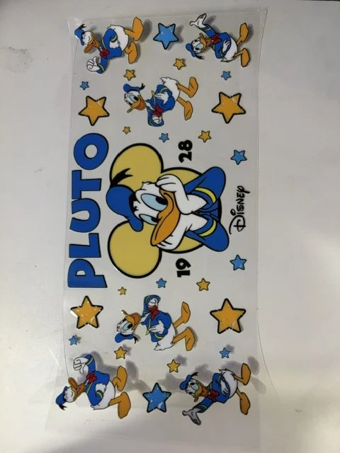 A Disney sticker sheet featuring Donald Duck surrounded by stars, with the words 'PLUTO' and images of Pluto the dog in various poses.