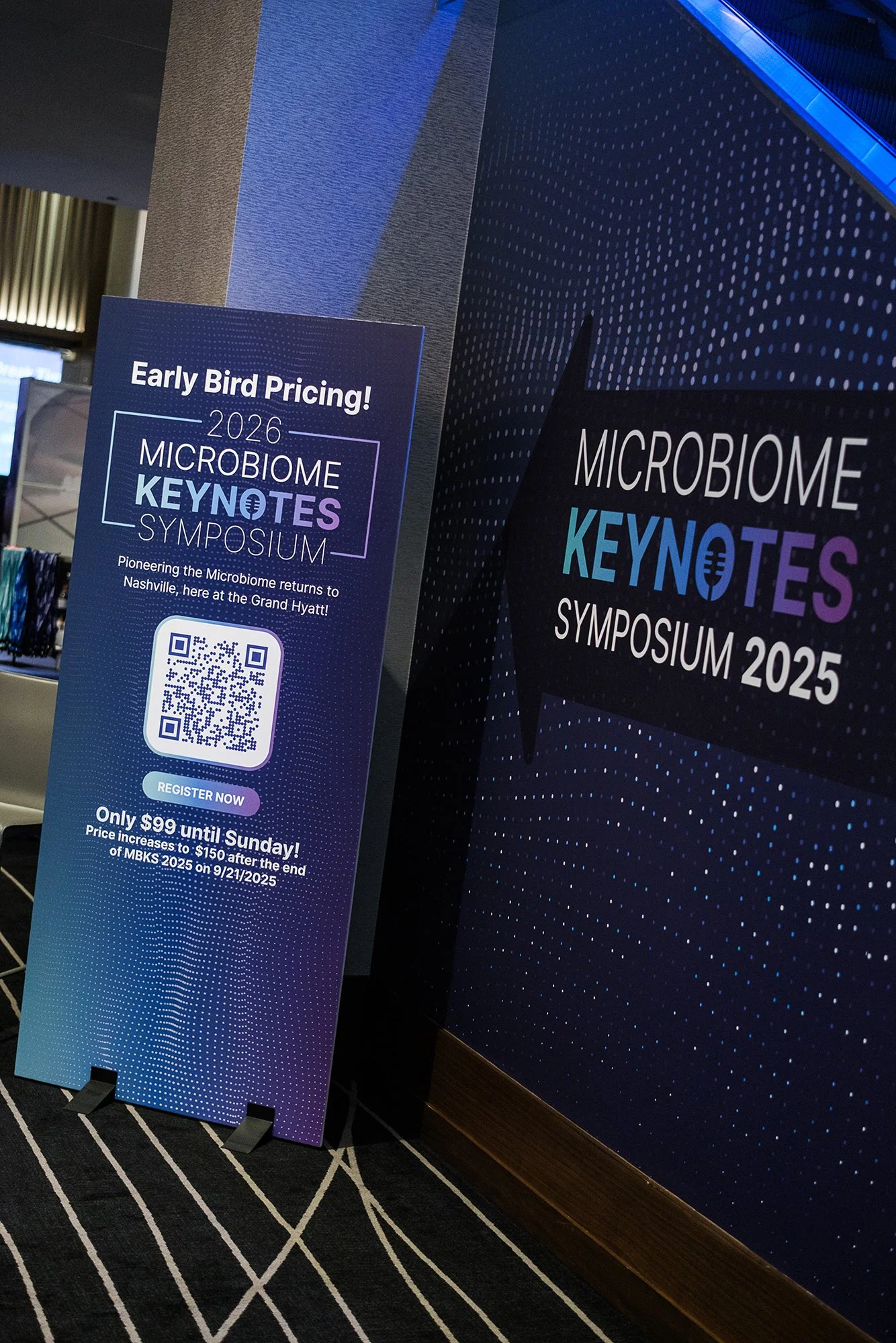Sign promoting the 2026 Microbiome Keynotes Symposium with early bird pricing details, QR code for registration, and the event taking place at the Grand Hyatt in Nashville.