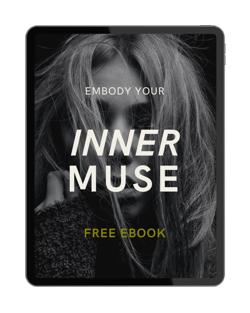 A black and white image of a woman with messy hair on a tablet screen, with the text 'Emboddy Your Inner Muse' and 'Free Ebook'.