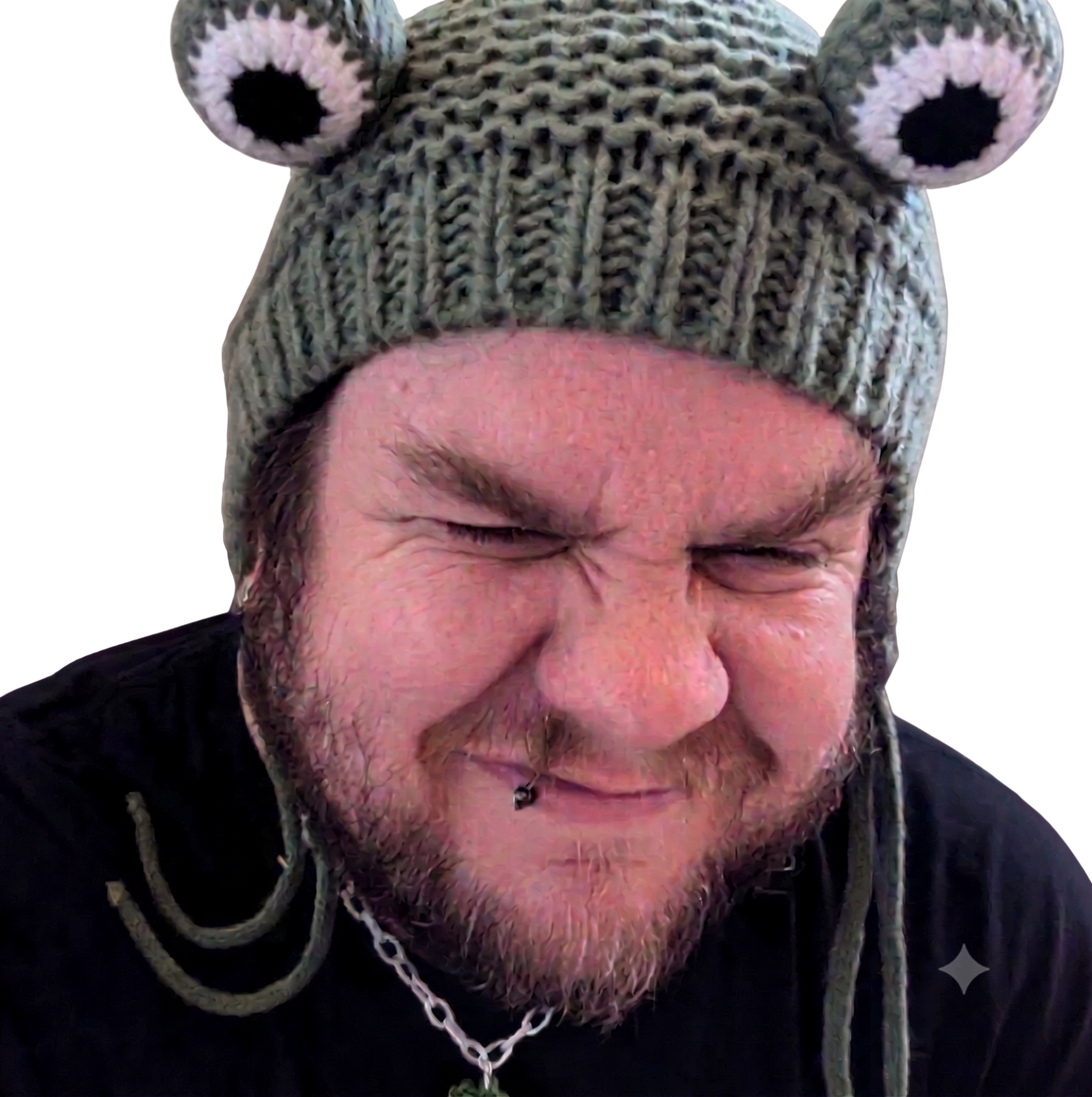 A knitted green frog hat with big round eyes, sitting on top of Noaksey