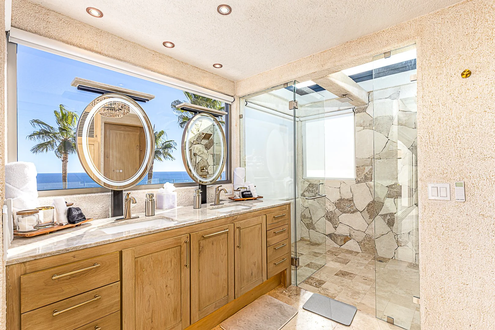 Luxury bathroom with his and hers sinks and ocean view at Casa Dos Hermanas in Cabo San Lucas