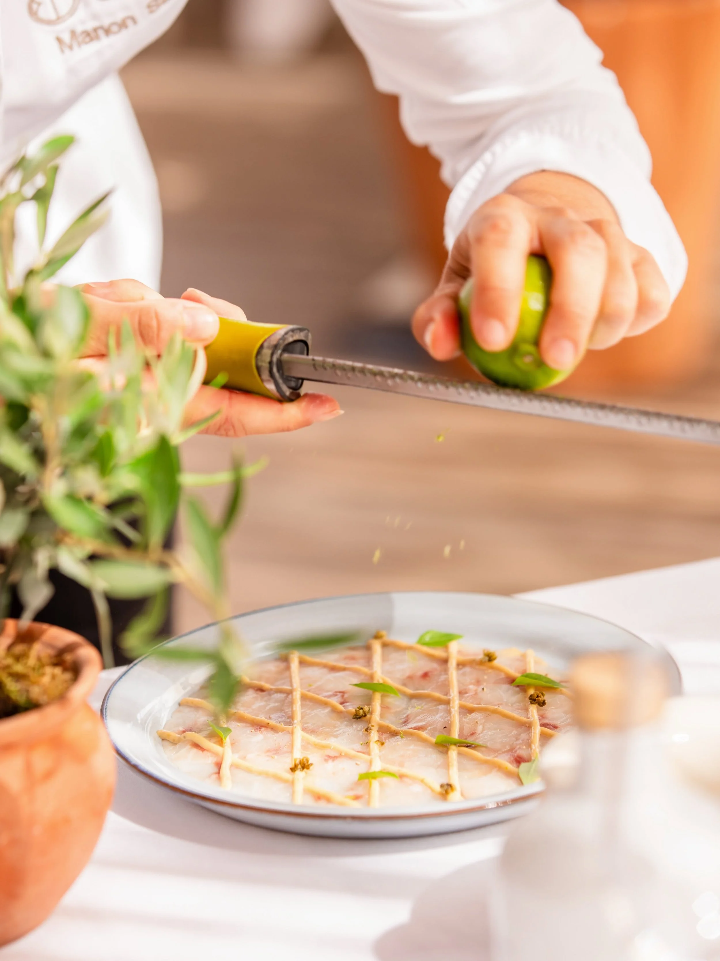 A person using a meat mallet to tenderize a green bell pepper.
