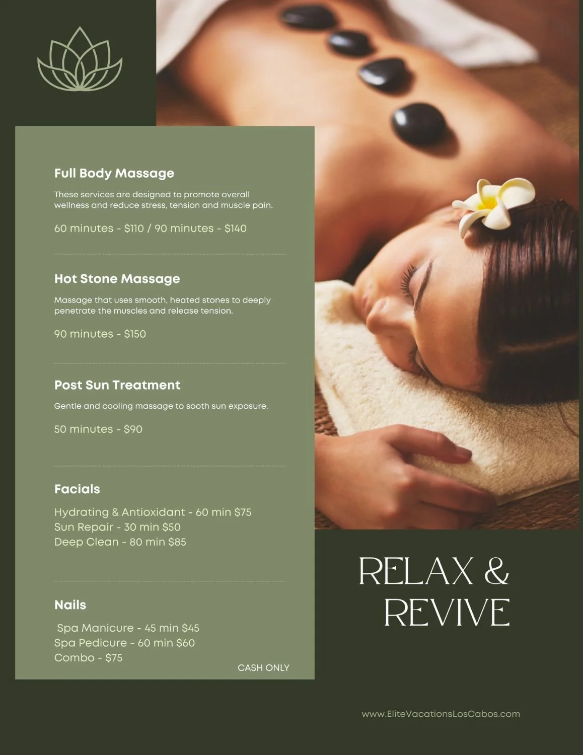 A woman receiving a hot stone massage, with smooth black stones placed along her back and flowers behind her ear, lying on her stomach with a towel covering her lower body.