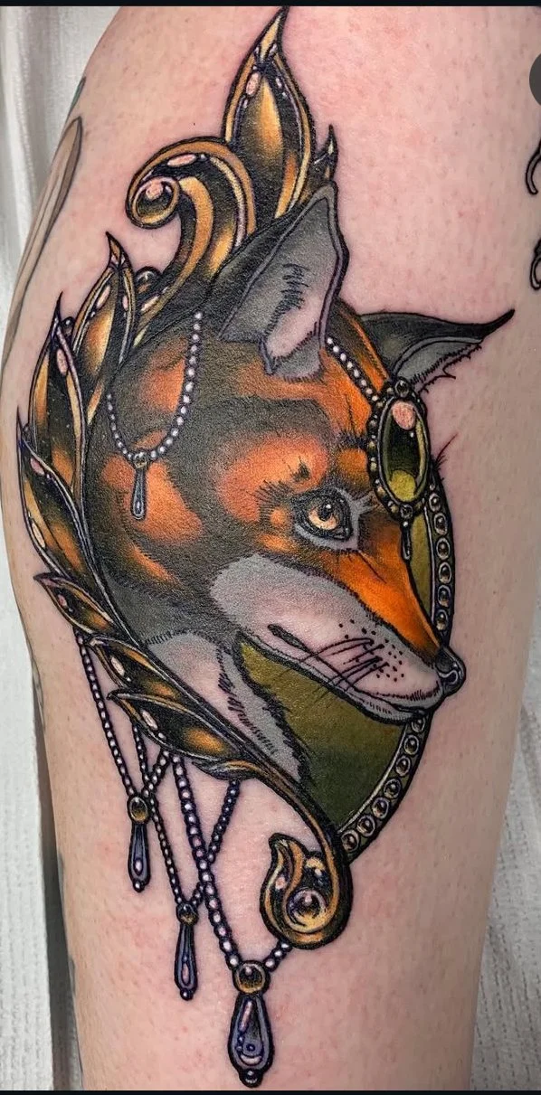 Tattoo of a fox with a jewelry and decorative frame. Neo traditional Tattoo.