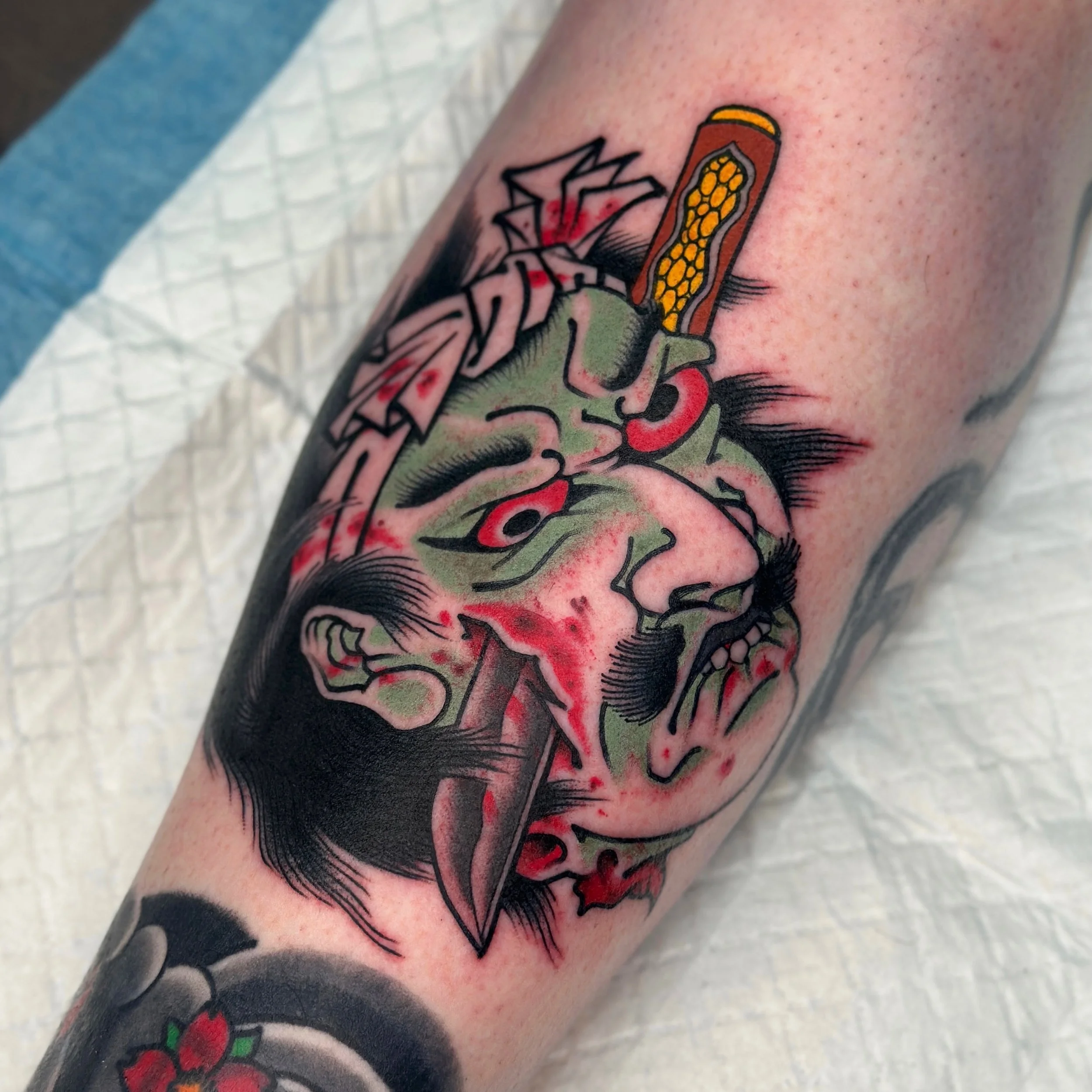 Tattoo of a colourful nanakubi on a person's arm. Bold Japanese traditional tattoo.