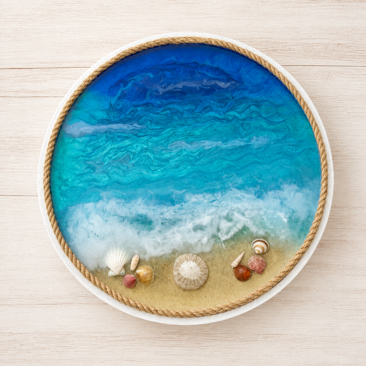 Decorative wooden round tray with a handcrafted resin beach scene with blue ocean water, sand, shells, edged with a rope border.