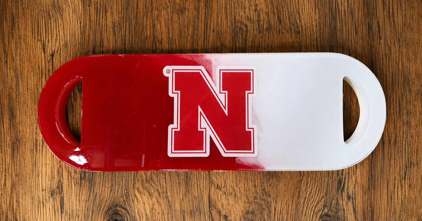 A rectangular plastic tray with a large red letter 'N' on the left half and a white background on the right, placed on a wooden surface.