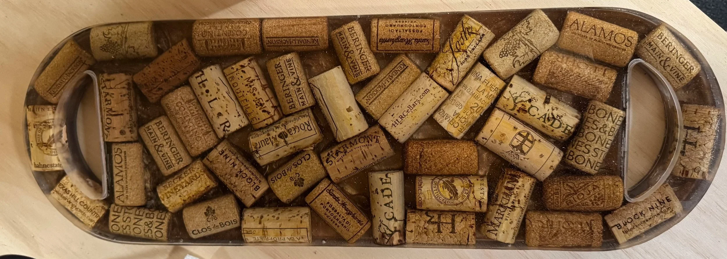 A glass container filled with wine corks submerged in water.