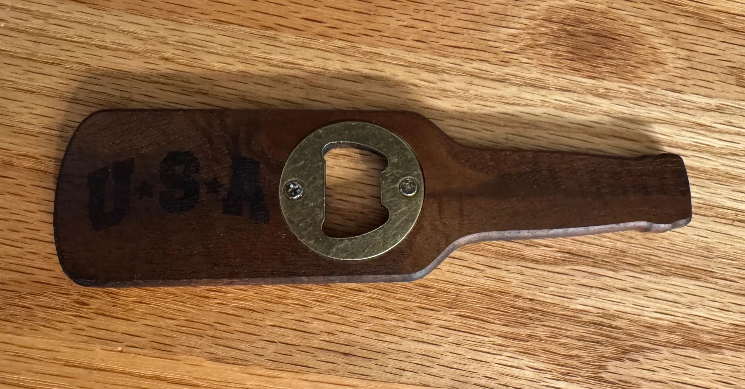 A wooden bottle opener with engraving for any occasion.