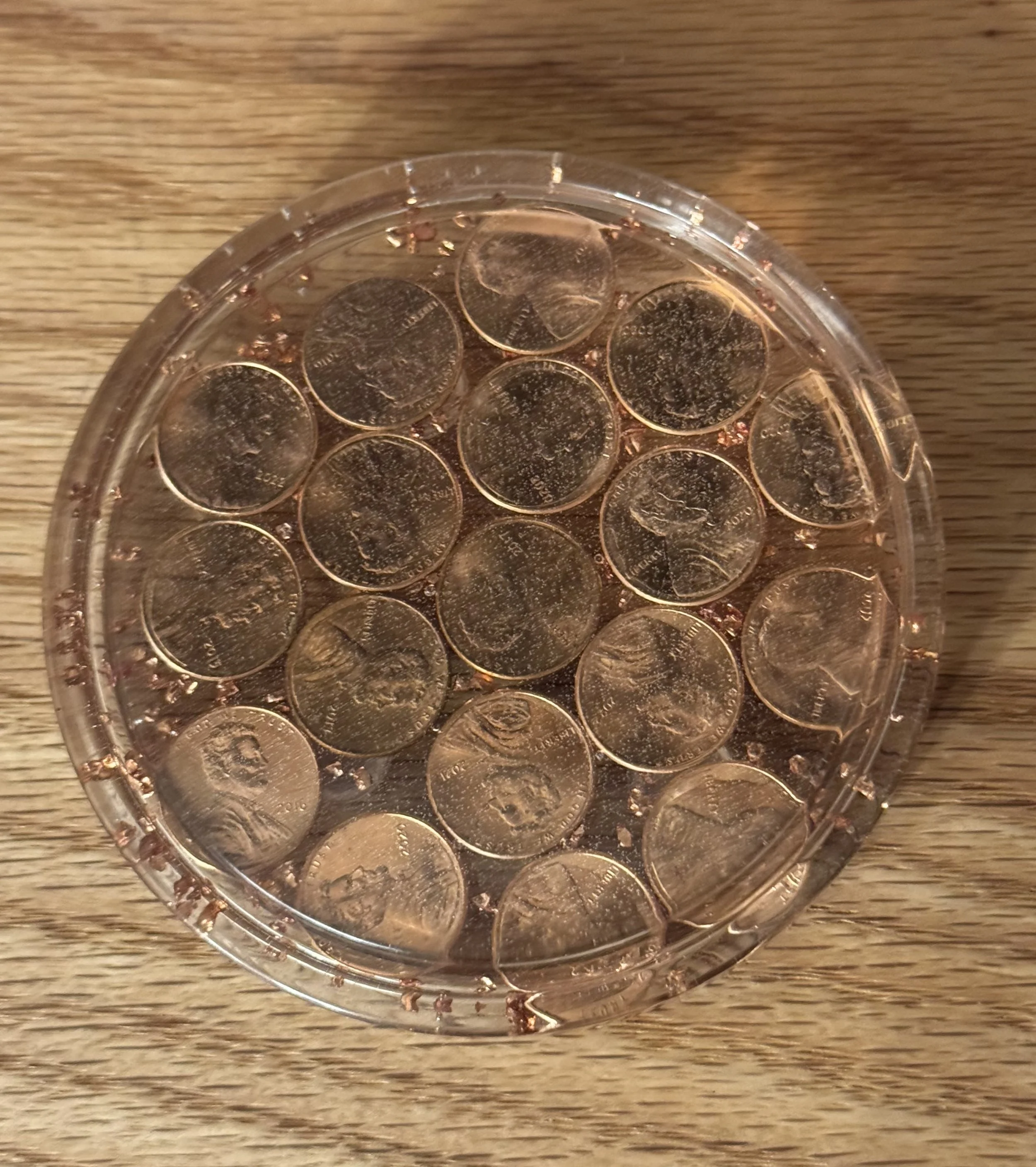 A coaster to commemorate the US penny with pennies embedded in crystal clear resin.  
