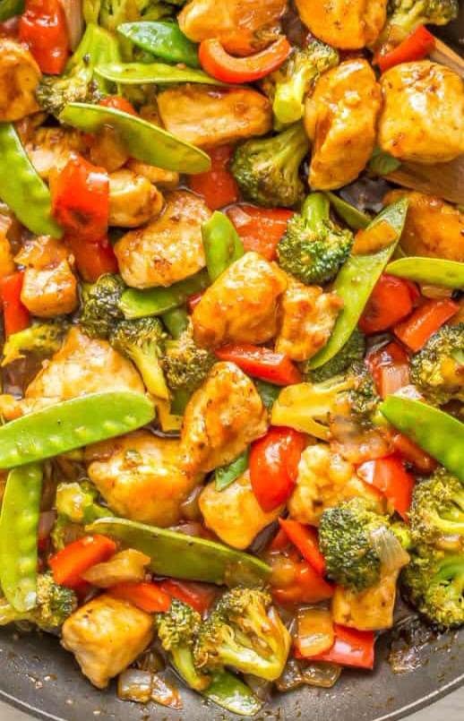 Stir-fried chicken with broccoli, snap peas, and red bell peppers.