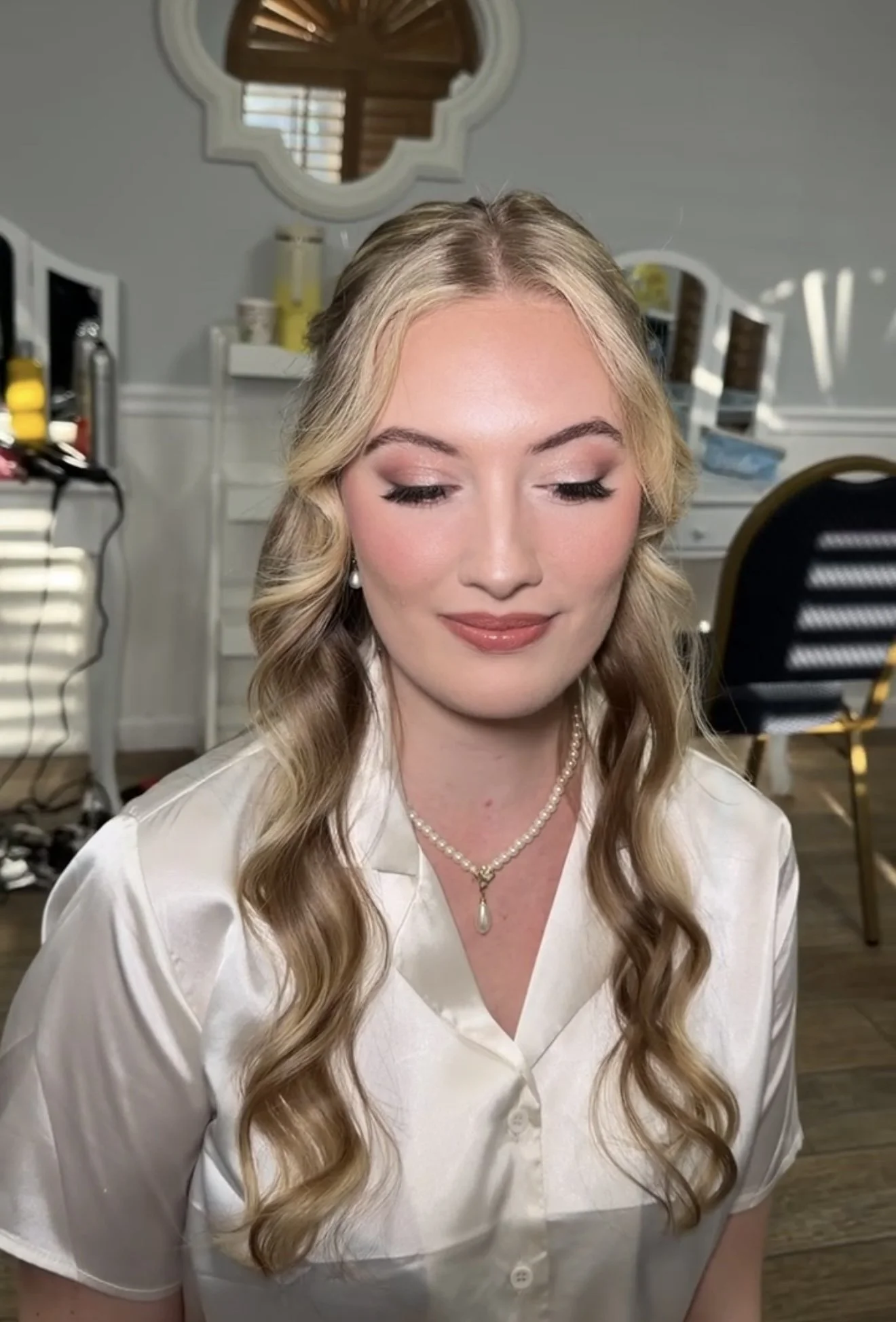 romantic soft bridal glam on a bride with a classic half up half down 