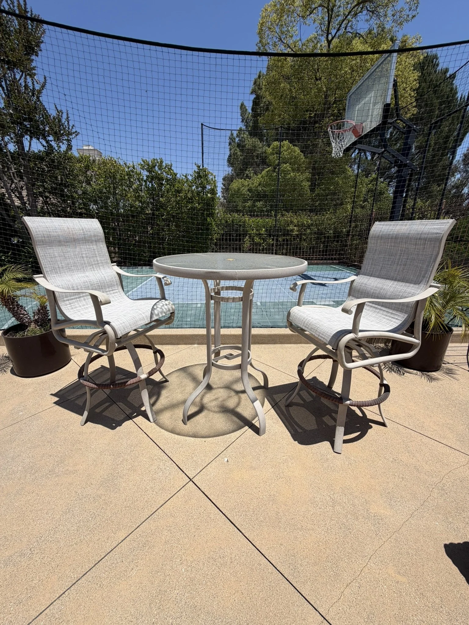 A restored gray sling patio set returned to a customer’s poolside space.