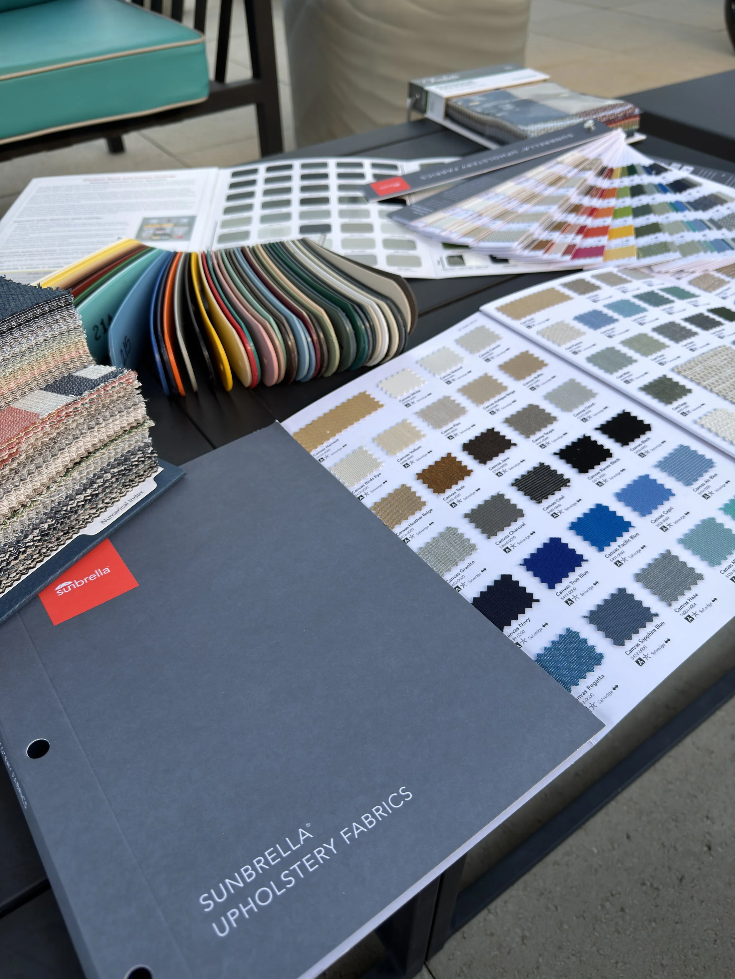 Colorful outdoor performance fabric swatches for sling and cushion material selection.