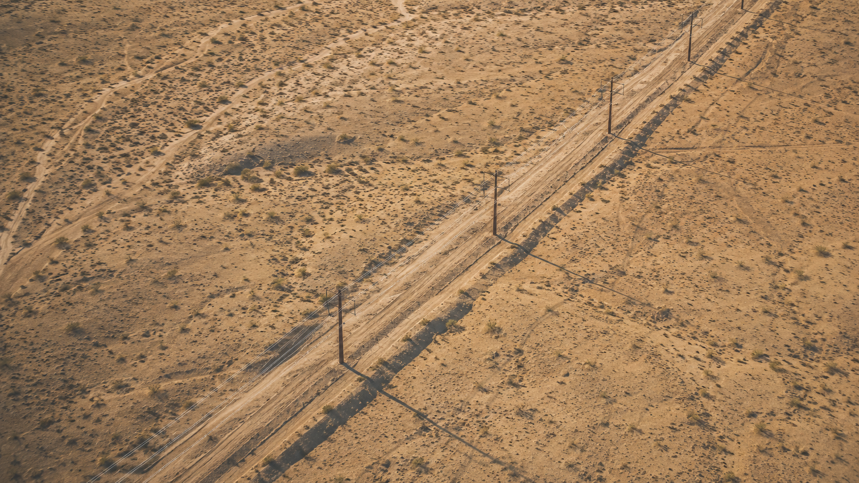 Birds-eye-view images of a row of powerlines in the Nevada desert