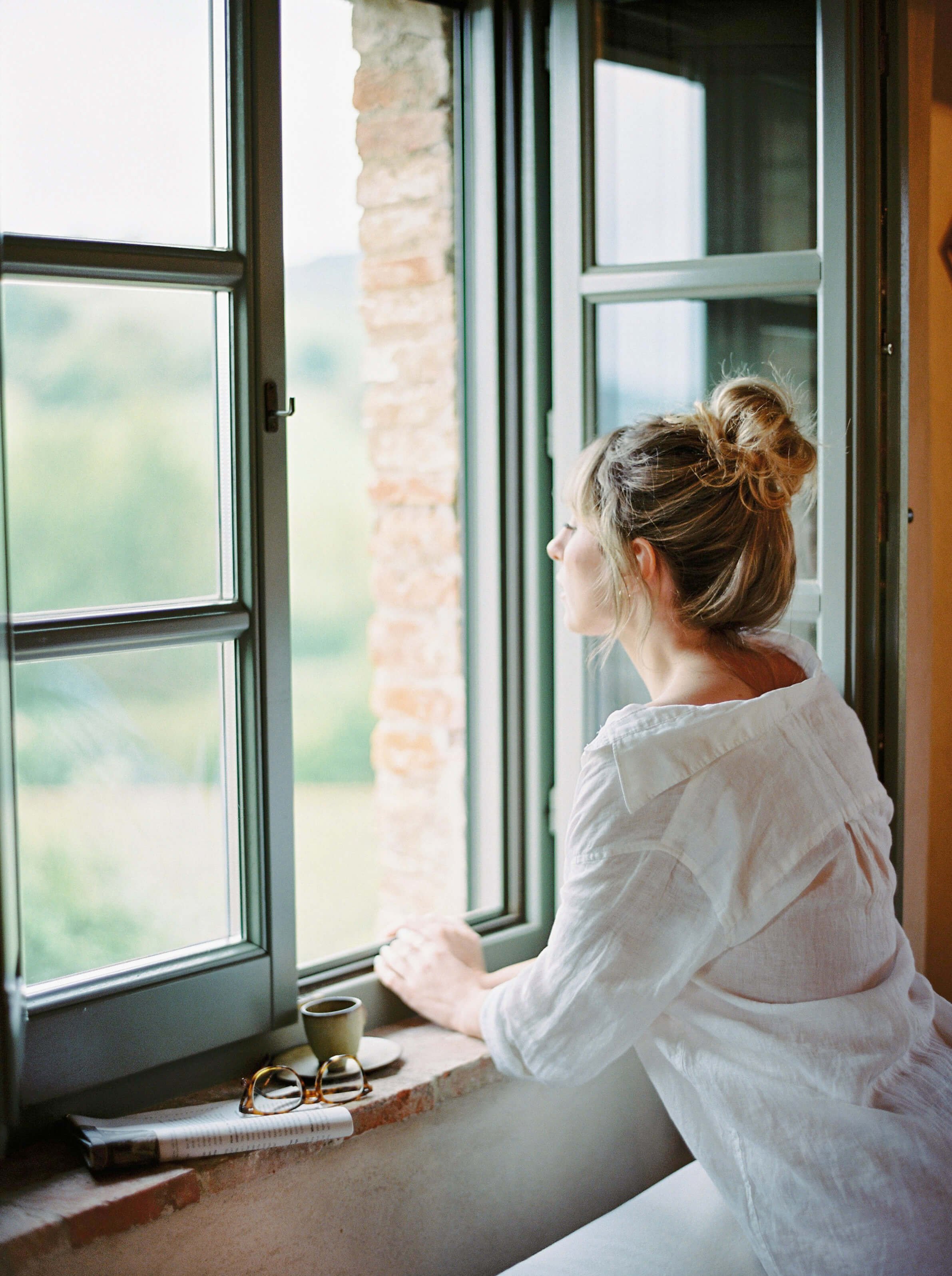 Sora Sol | Woman looks out the window