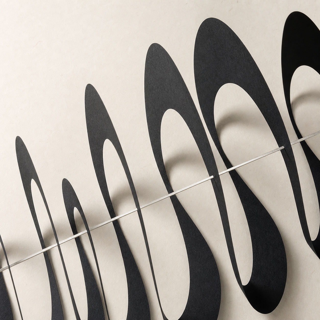 Layered charcoal paper sound waves crossed by a silver line