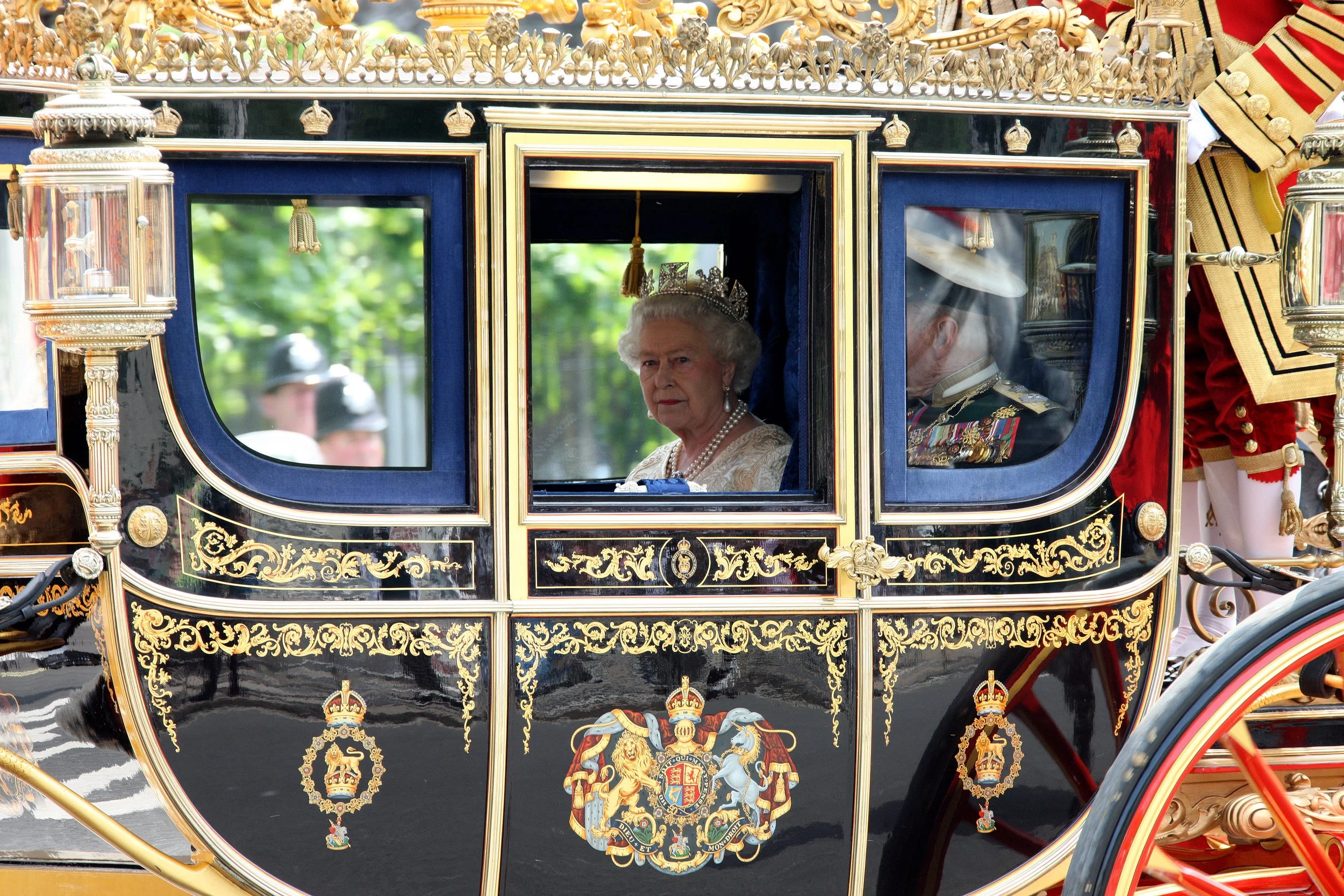 Queen Elizabeth II inside a decorated royal carriage during a after state opening of parliament 