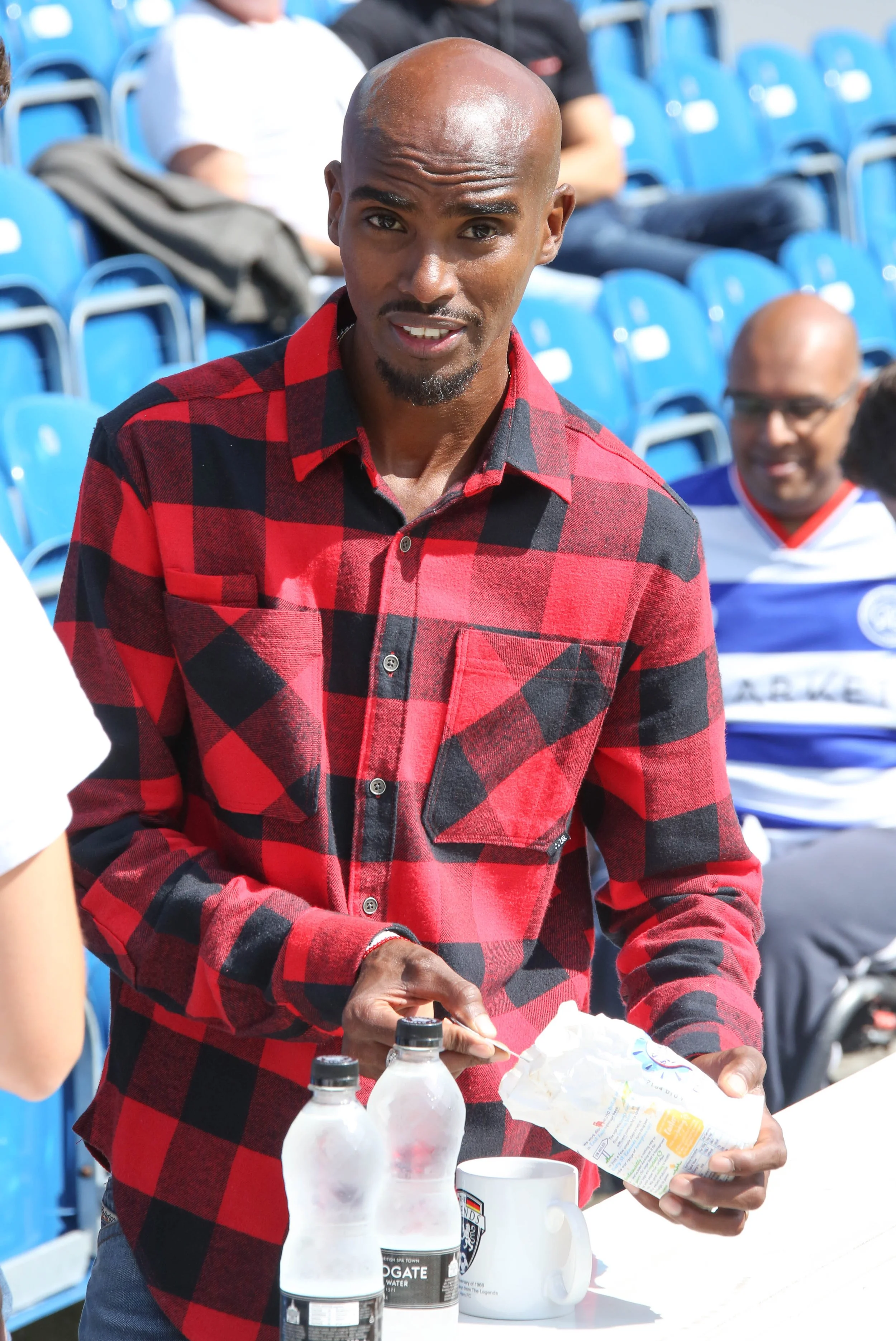 Mo Farrah makes tea before "game for grenfell" football match Loftus Road London 