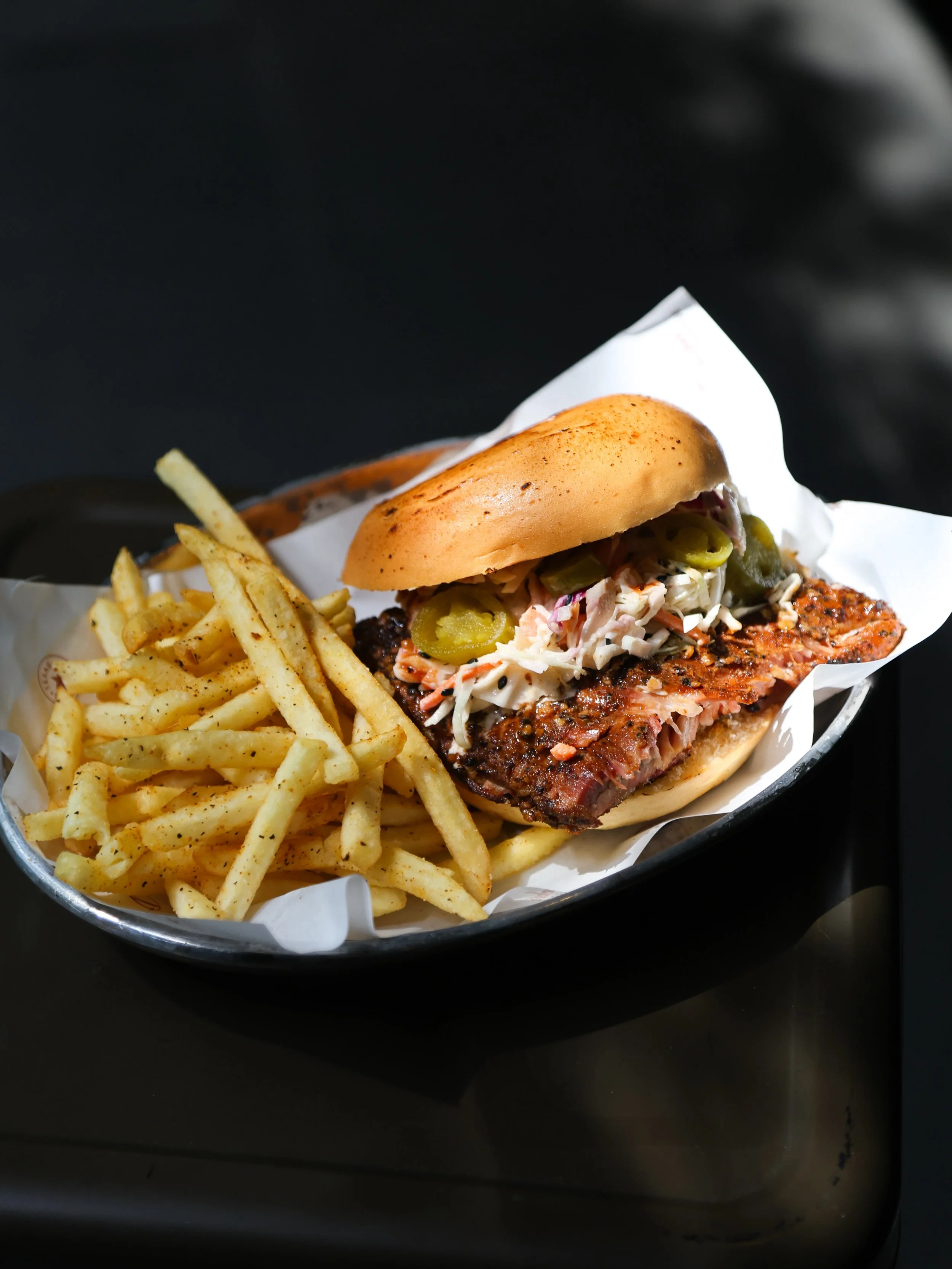 Messy in the best way, and built for a good lunch break. Our BBQ Sandwich comes with a brioche bun, slaw, pickled jalape&ntilde;os, BBQ sauce, fries, and your choice of meat.

Keep it classic with pulled pork or smoked chicken, or go bigger with bris