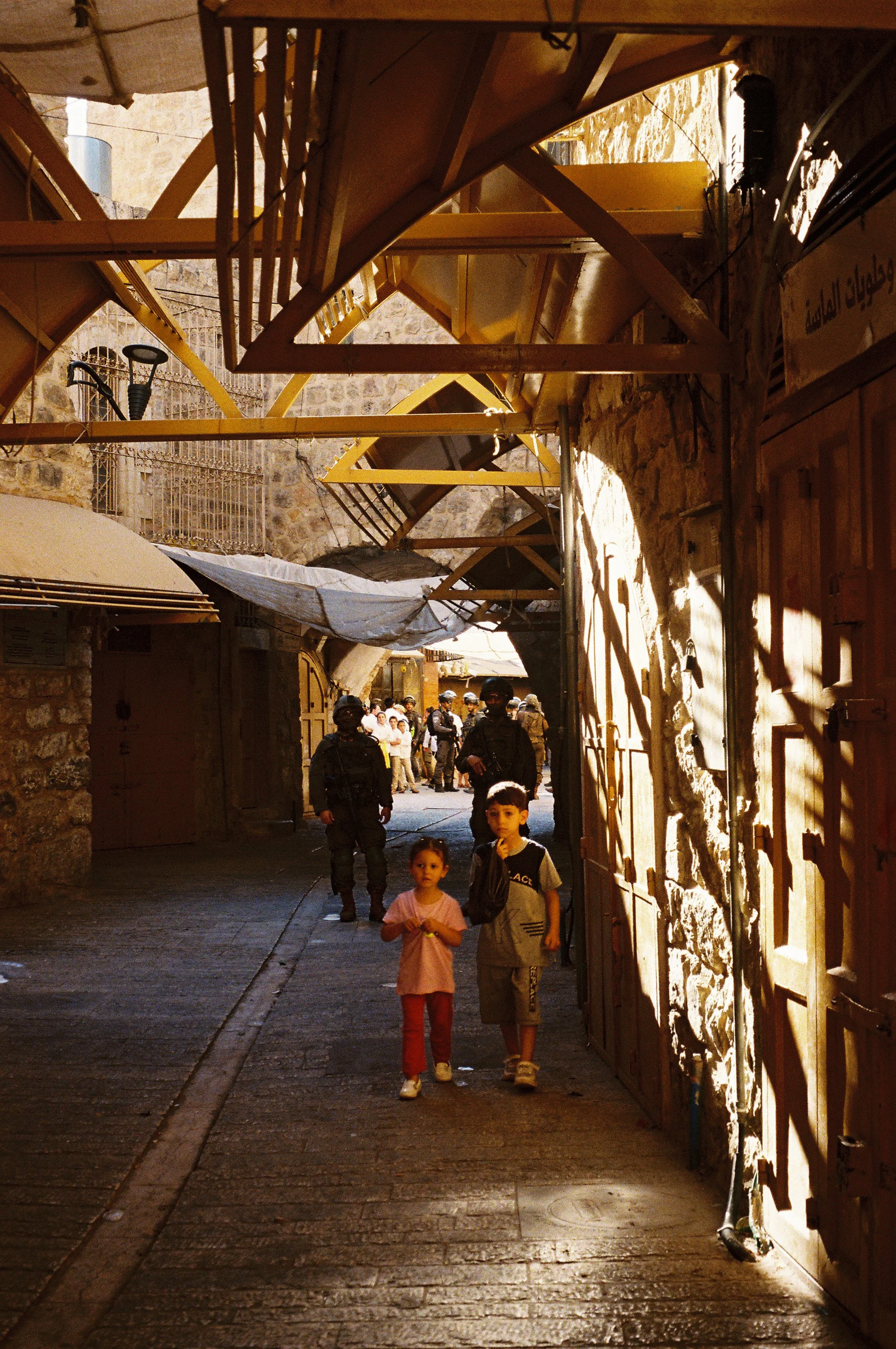 Palestinian Children with IOF in Background During Hebron Settler Tour