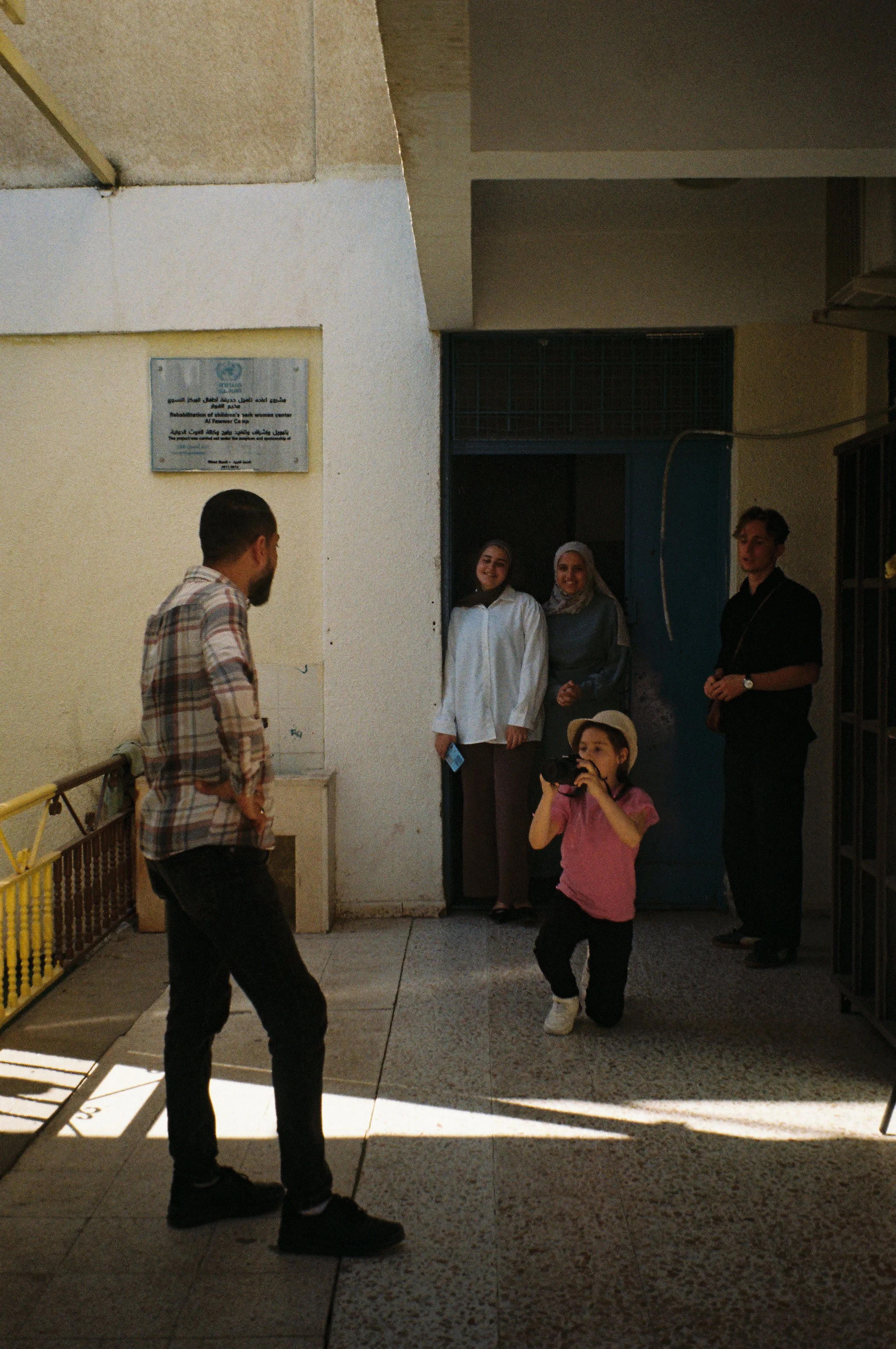 Osama Poses for Photo by Young Student