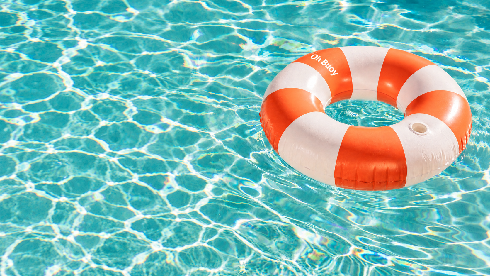 A life preserver float with orange and white stripes in a swimming pool.