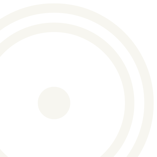 Close-up of a vinyl record with a white label at the center, showing the black grooves and outer edge.