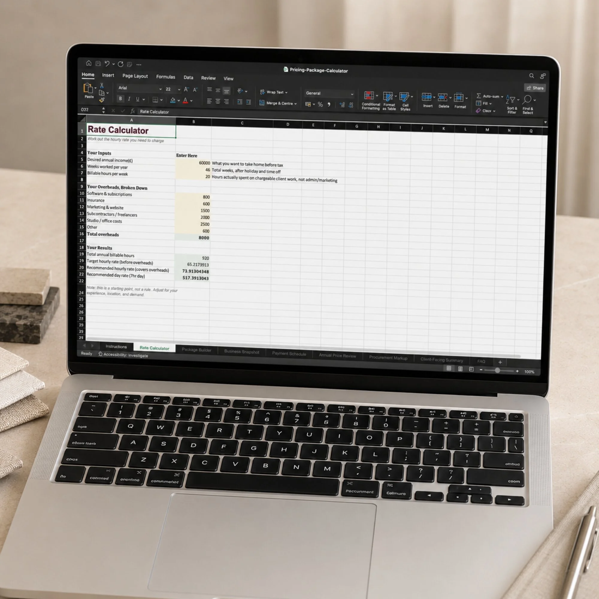 The Pricing and Package Calculator open on a laptop for interior designers
