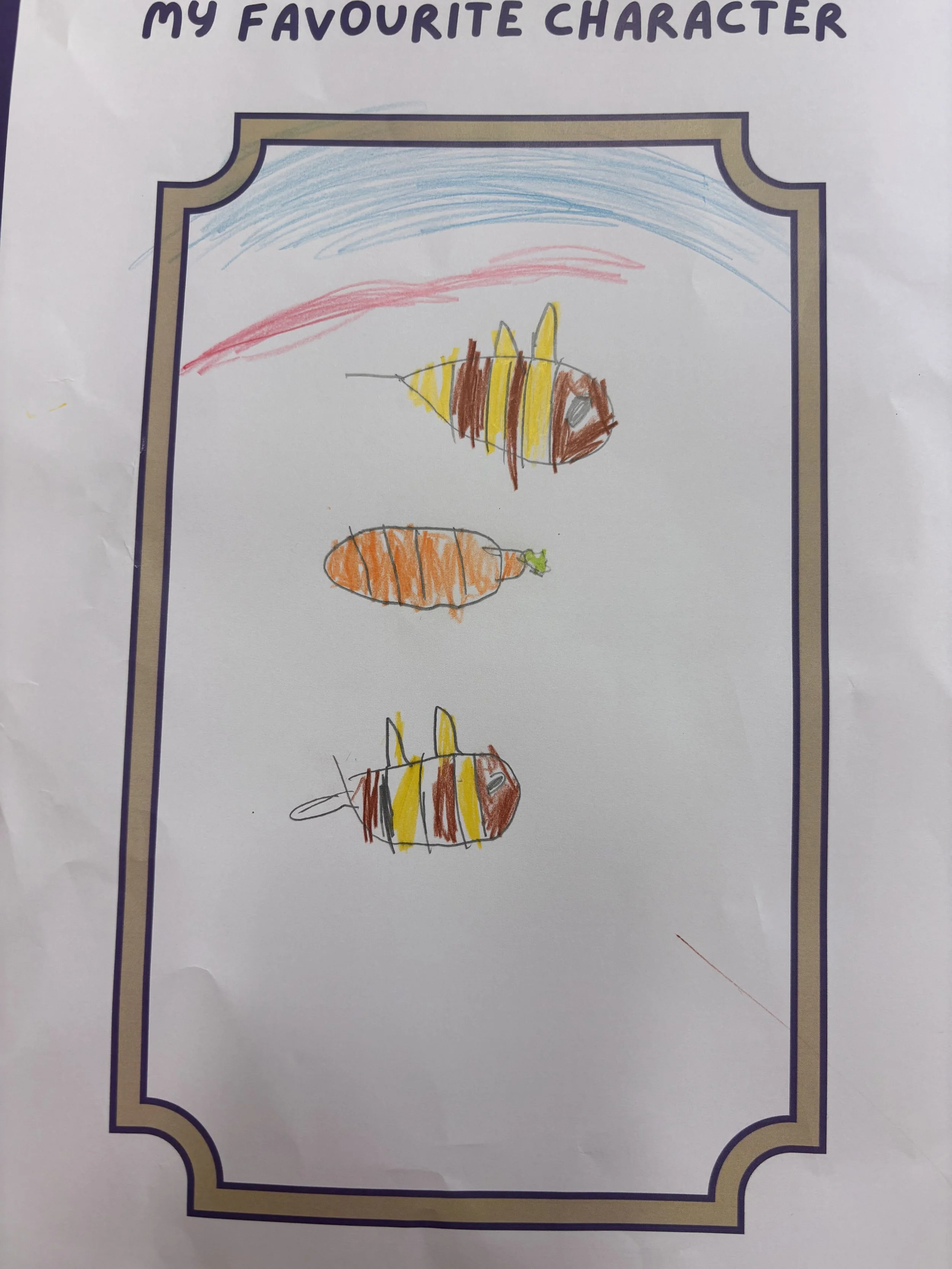A child's drawing of three fish colored with yellow, brown, and orange, with one fish having a gray eye. The picture has rainbow-like arcs in blue and pink in the background. It is part of a white paper decorated with a purple border, with the title "My Favorite Character" at the top.