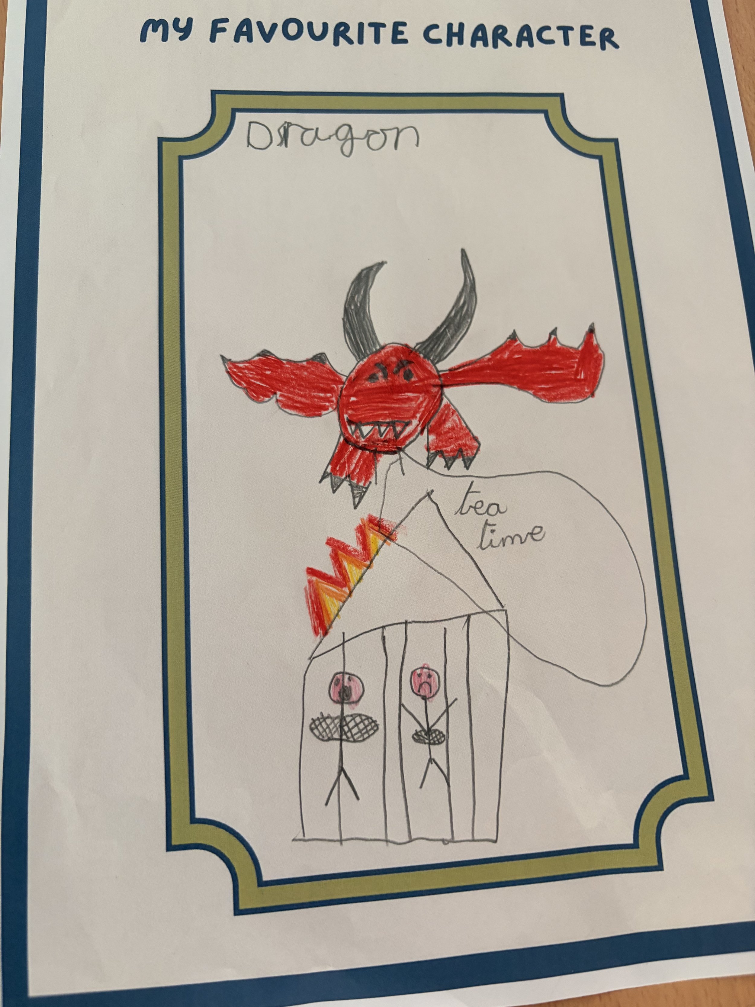 Colorful child's drawing of a creature with a red head, red wings, black horns, and a smiling face. The creature has four legs with three pink circles on its feet. The drawing is on a piece of paper with the words 'MY FAVOURITE CHARACTER' written at the top and the name 'Dragon' handwritten above the creature.