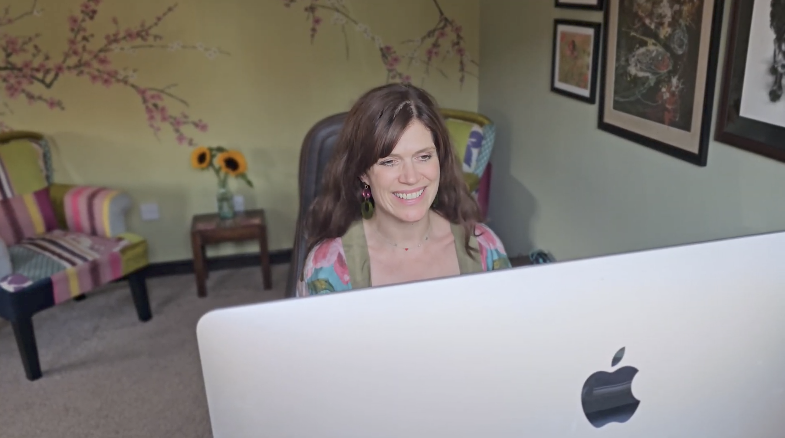 Katie, founder of Optimise, working at her computer.