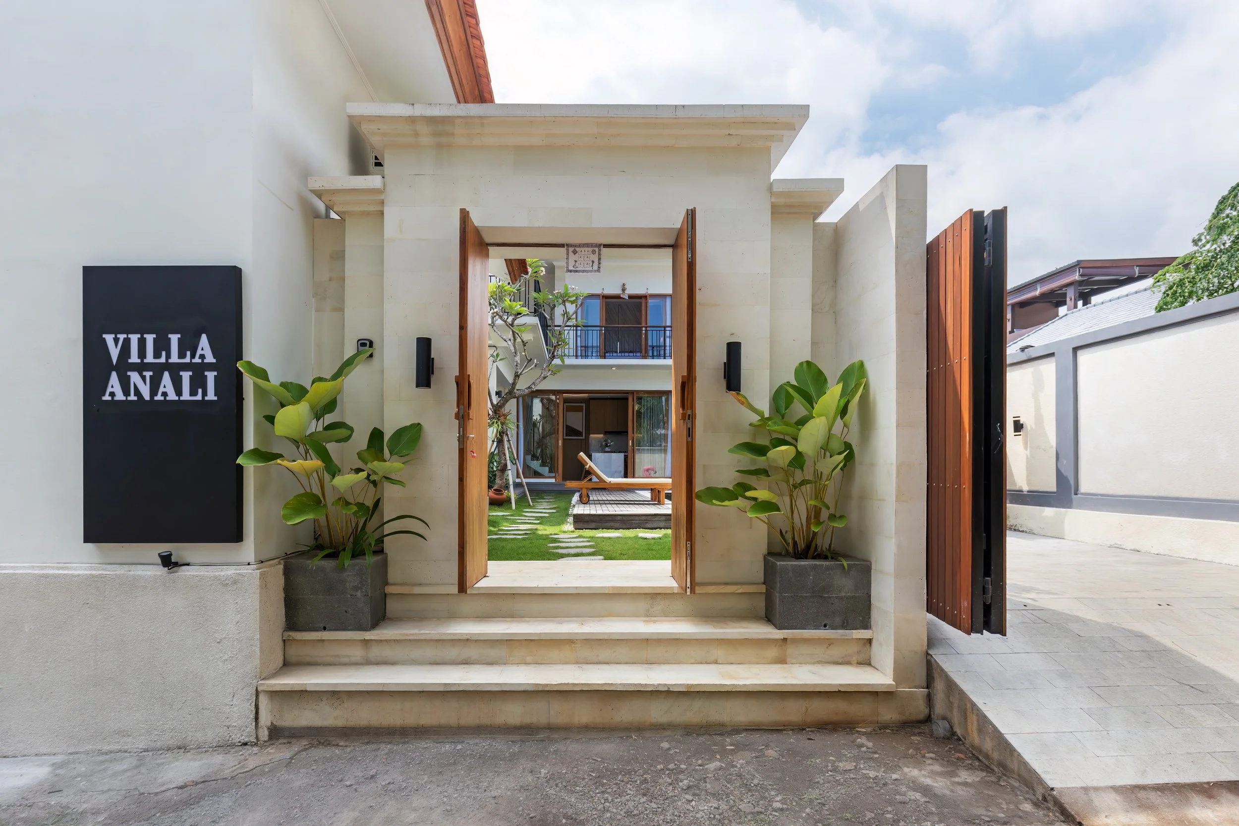 Entrance to Villa Anali with open gates and tropical landscaping in Lovina