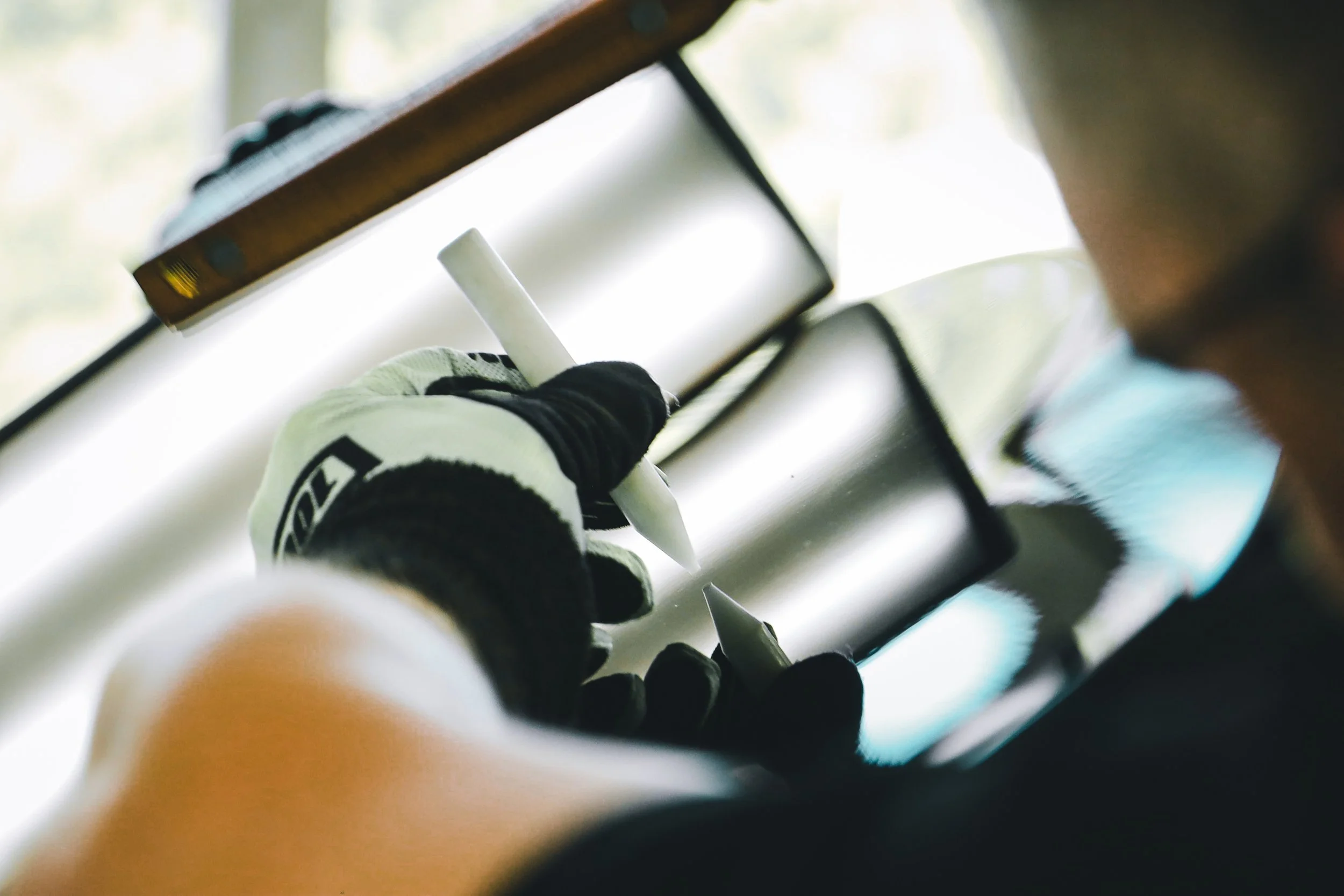 Close-up of PDR expert's hands working on the dents on the tailgate cover photographed by Annika TheVolvoGirl Miftakhova in Helsinki, Finland