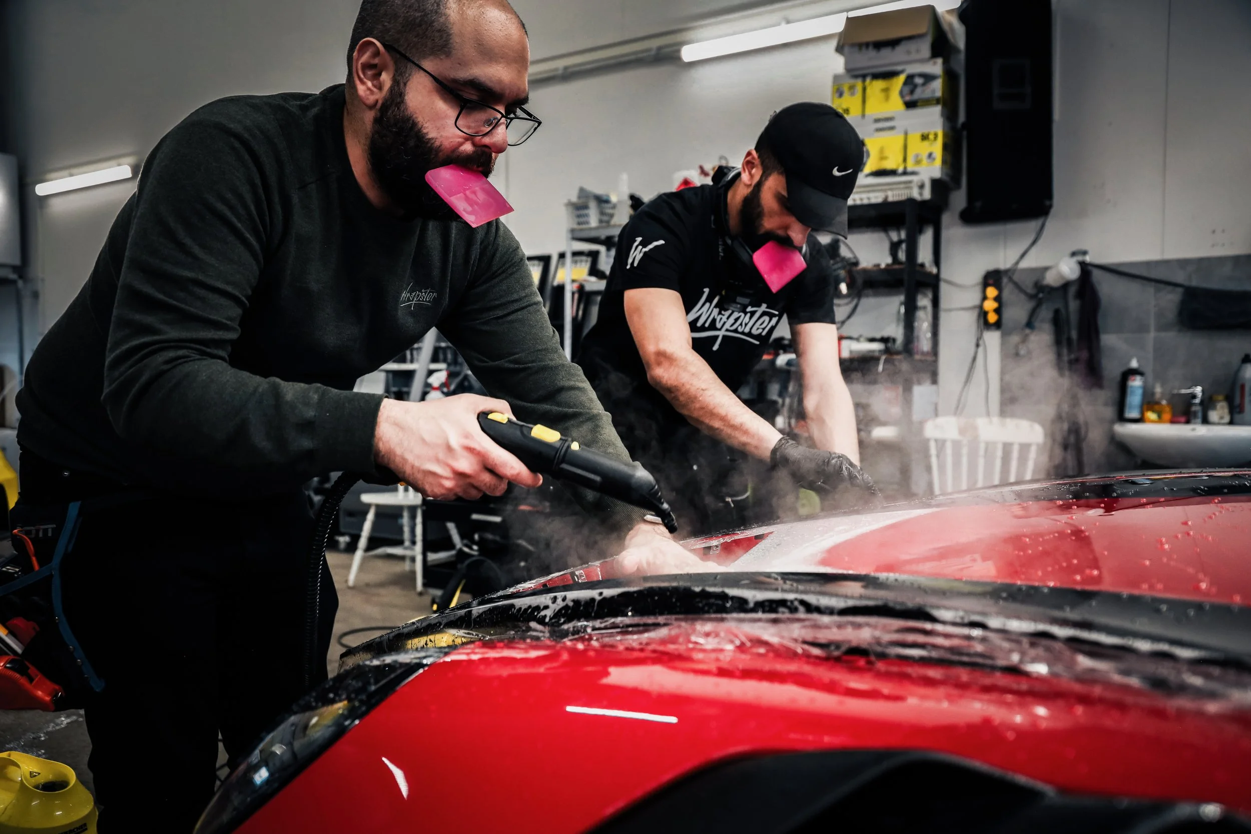 Wrapster workers stretch and install Paint Protection Film on the Red Porsche GT3 RS in Örebro, Sweden, photographed by Annika TheVolvoGirl Miftakhova.