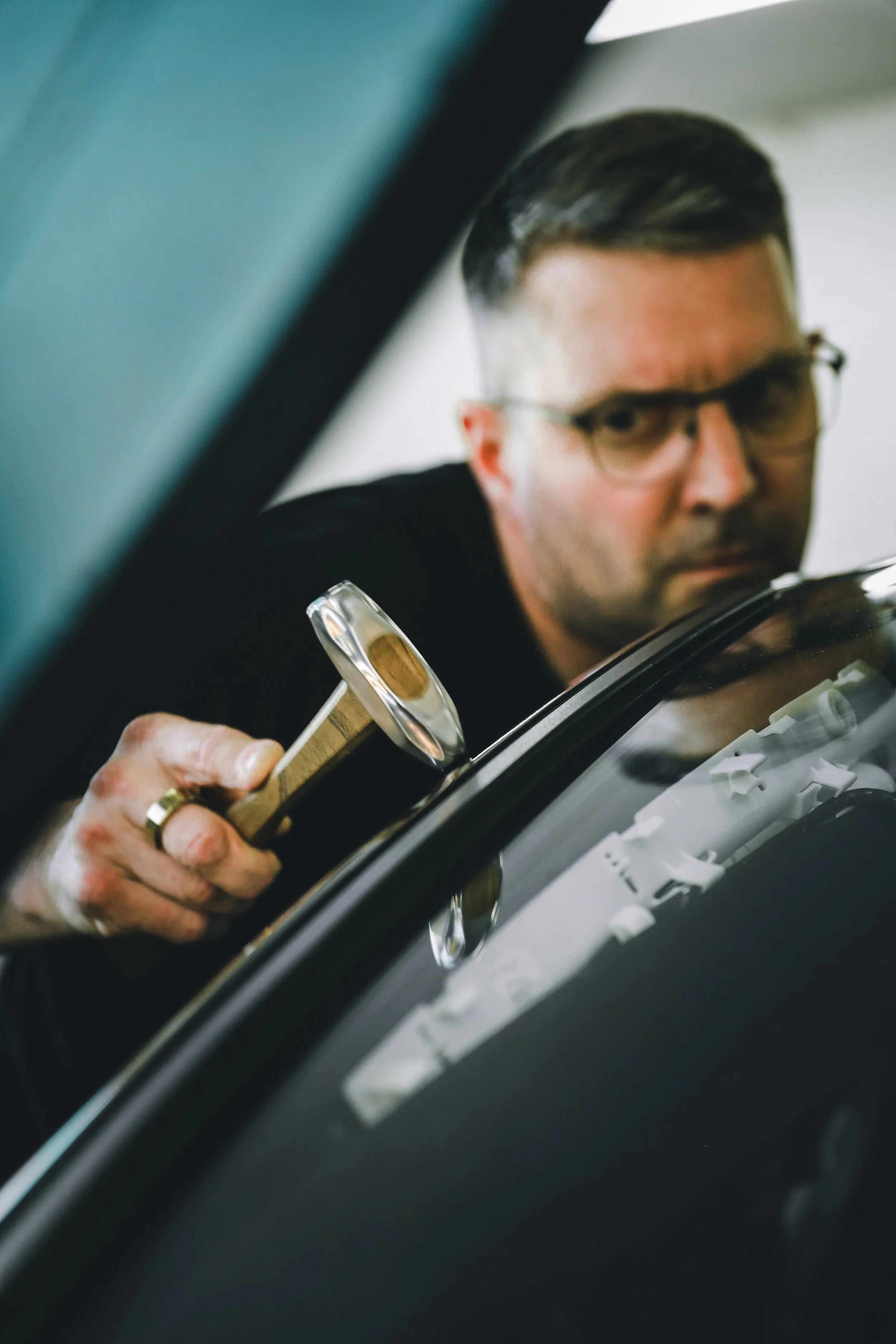 PDR expert working on dents on the steel A-pillar of the car photographed by Annika TheVolvoGirl Miftakhova in Helsinki, Finland