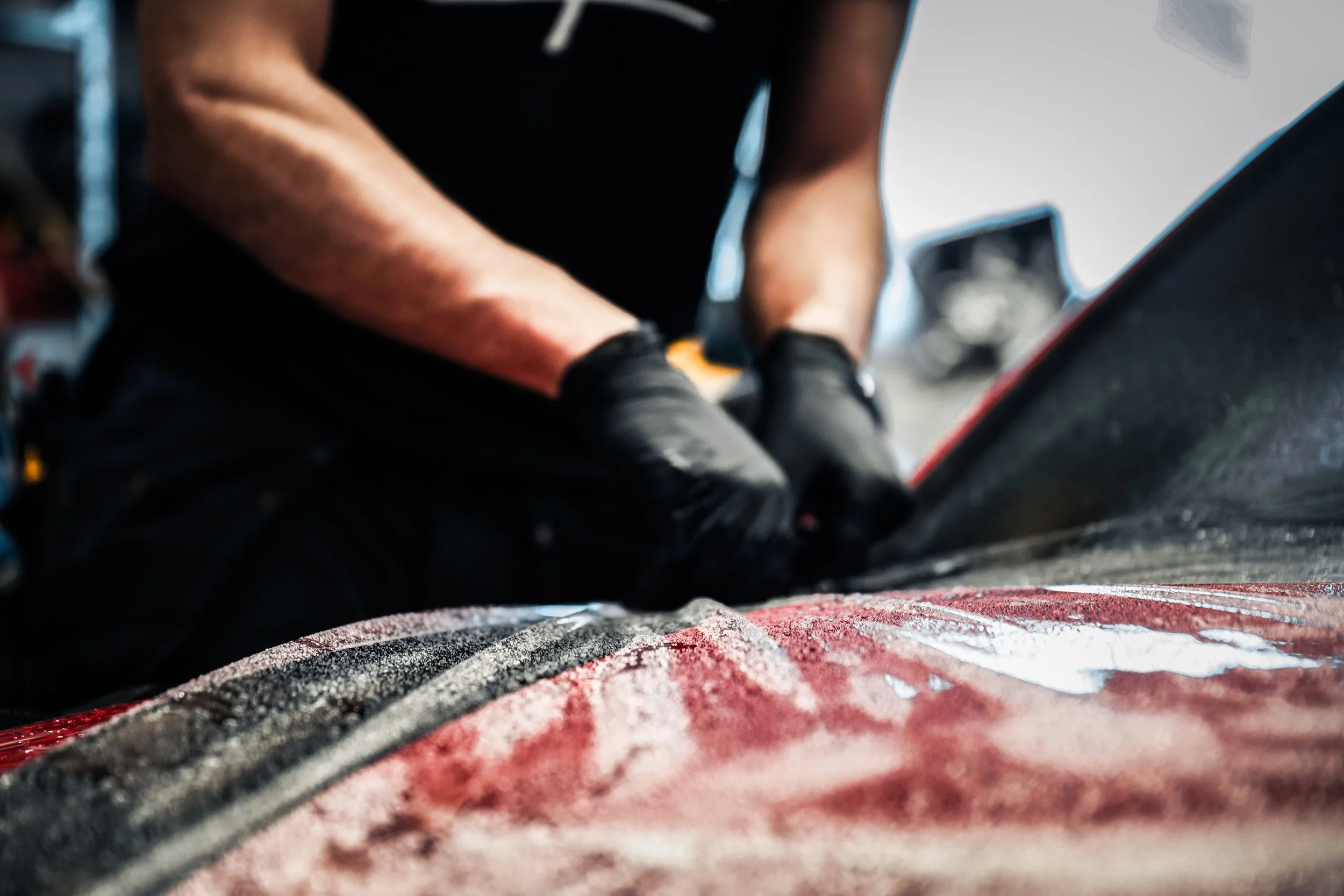 Wrapster workers place anchor points on Paint Protection Film on the Red Porsche GT3 RS in Örebro, Sweden, photographed by Annika TheVolvoGirl Miftakhova.