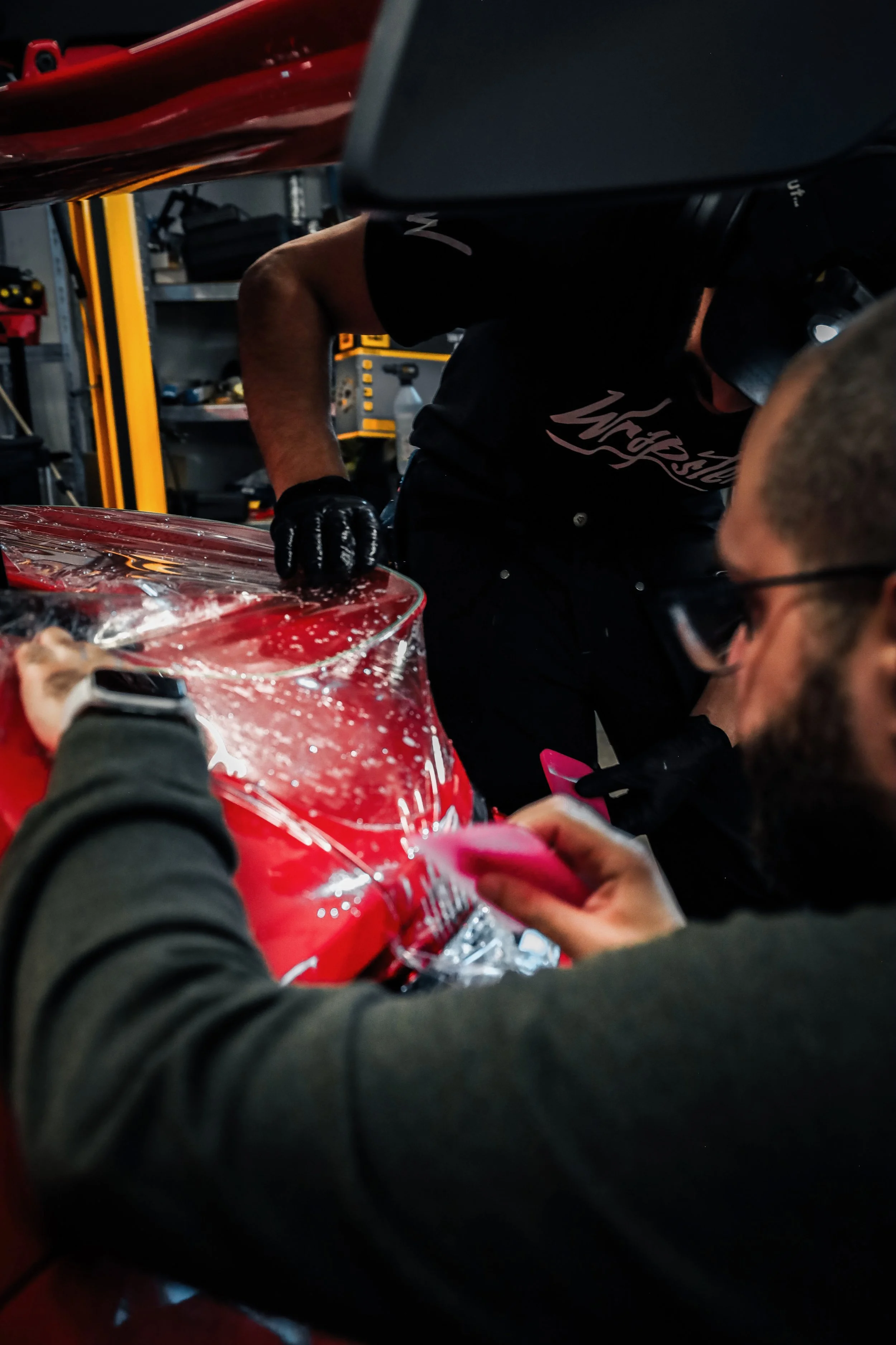 Wrapster workers install Paint Protection Film on the tail of Red Porsche GT3 RS in Örebro, Sweden, photographed by Annika TheVolvoGirl Miftakhova.