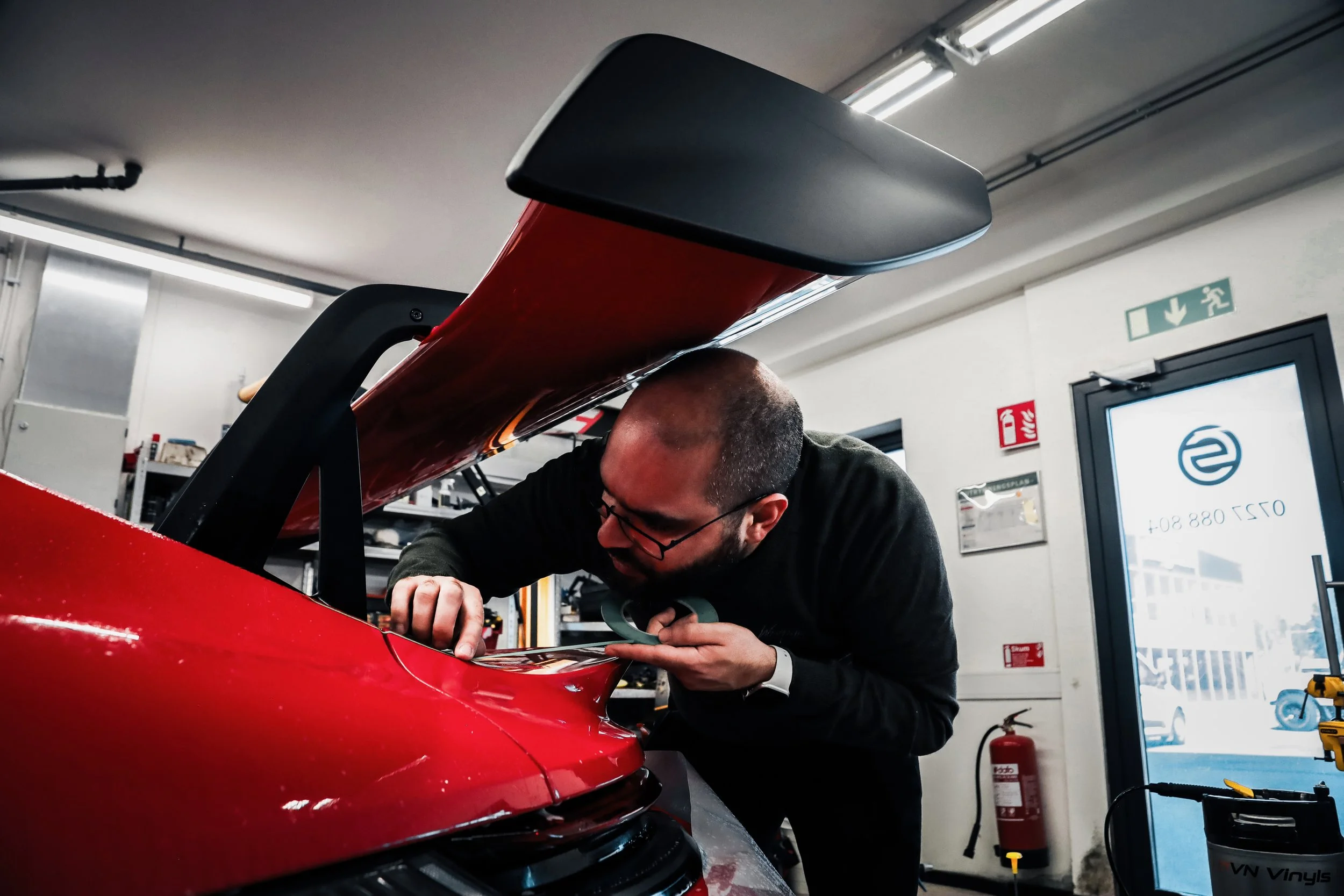Wrapster workers install Paint Protection Film on the tail of Red Porsche GT3 RS in Örebro, Sweden, photographed by Annika TheVolvoGirl Miftakhova.