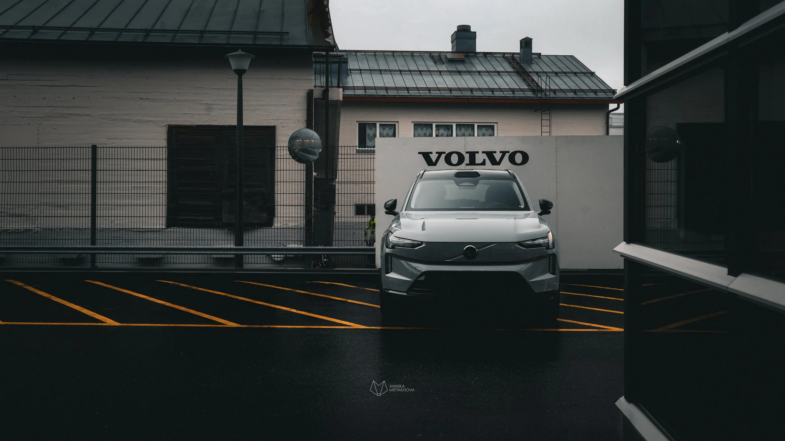 Grey Volvo EX90 photographed in rainy bright yellow parking lot in Helsinki by Annika TheVolvoGirl Miftakhova 