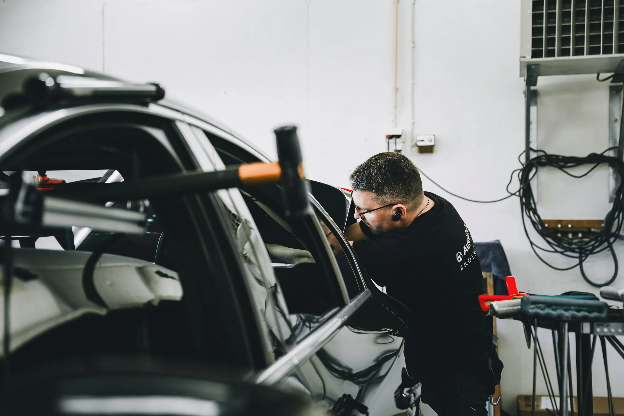 PDR professional working on rear of the car photographed by Annika TheVolvoGirl Miftakhova in Helsinki, Finland
