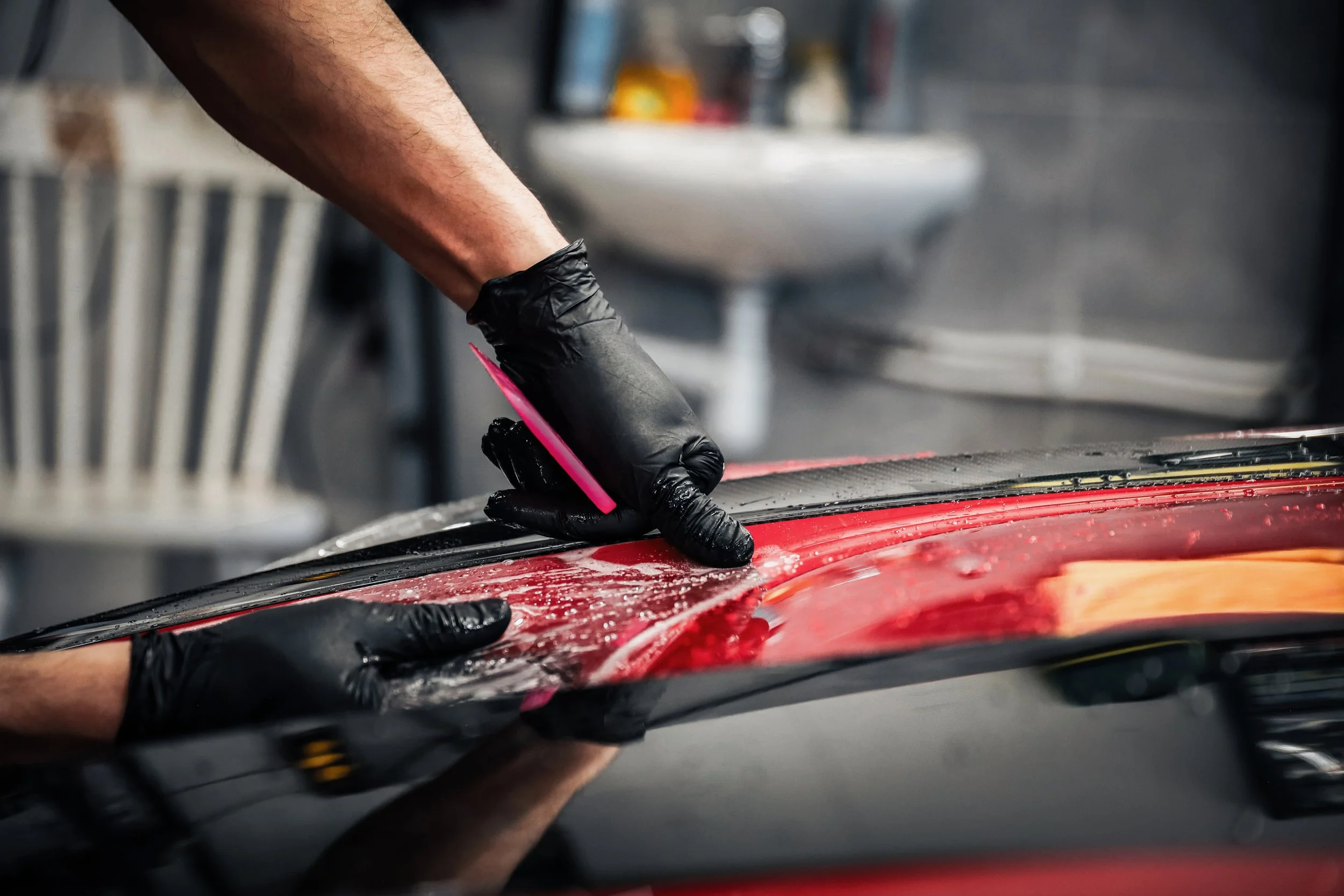 Wrapster workers install Paint Protection Film on the Red Porsche GT3 RS in Örebro, Sweden, photographed by Annika TheVolvoGirl Miftakhova.