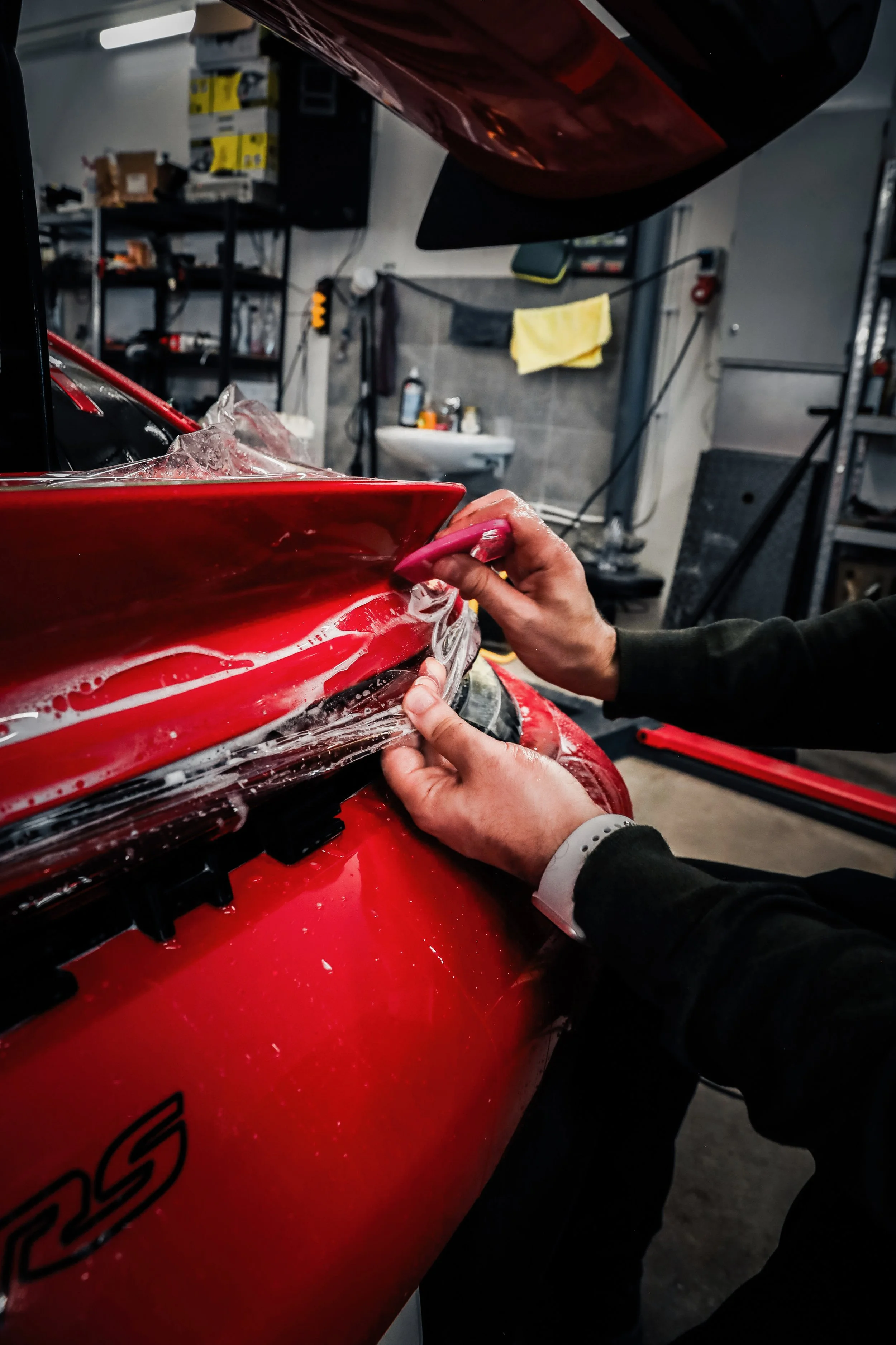 Wrapster workers install Paint Protection Film on the tail of Red Porsche GT3 RS in Örebro, Sweden, photographed by Annika TheVolvoGirl Miftakhova.