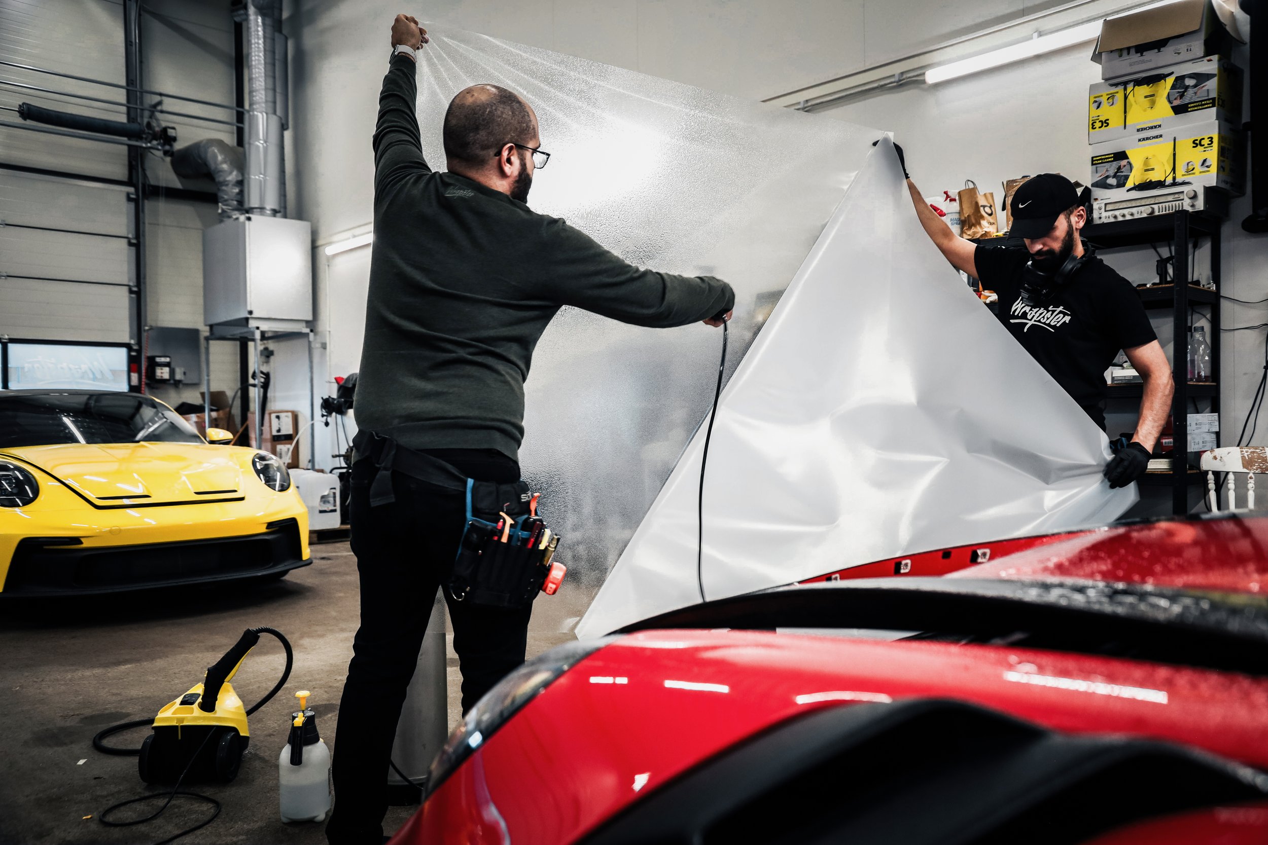 Wrapster workers water the Paint Protection Film before installation in Örebro, Sweden, photographed by Annika TheVolvoGirl Miftakhova.