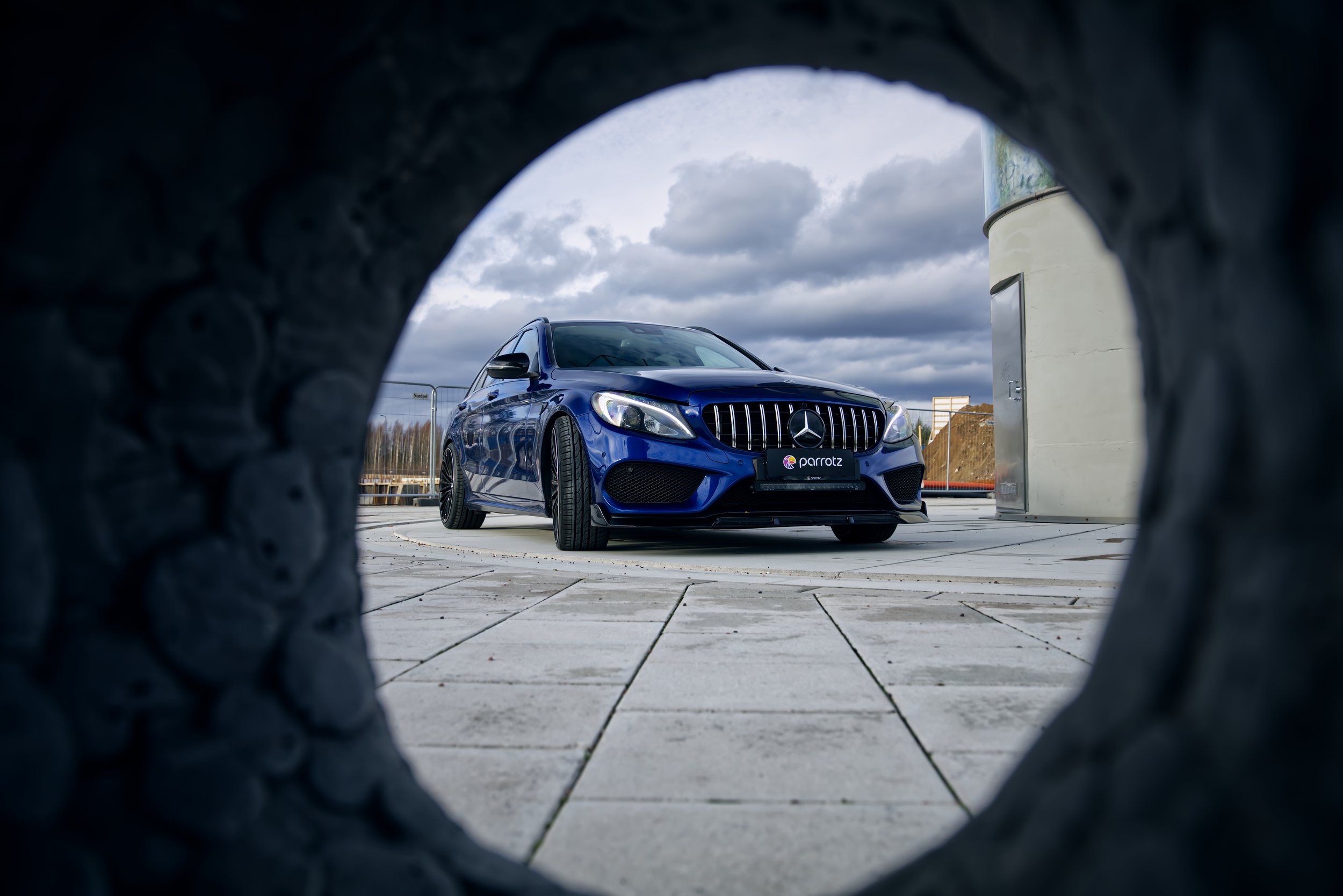 Front of Blue Mercedes-Benz C-class car photographed by Annika TheVolvoGirl Miftakhova for Parrotz Suomi in Helsinki, Finland
