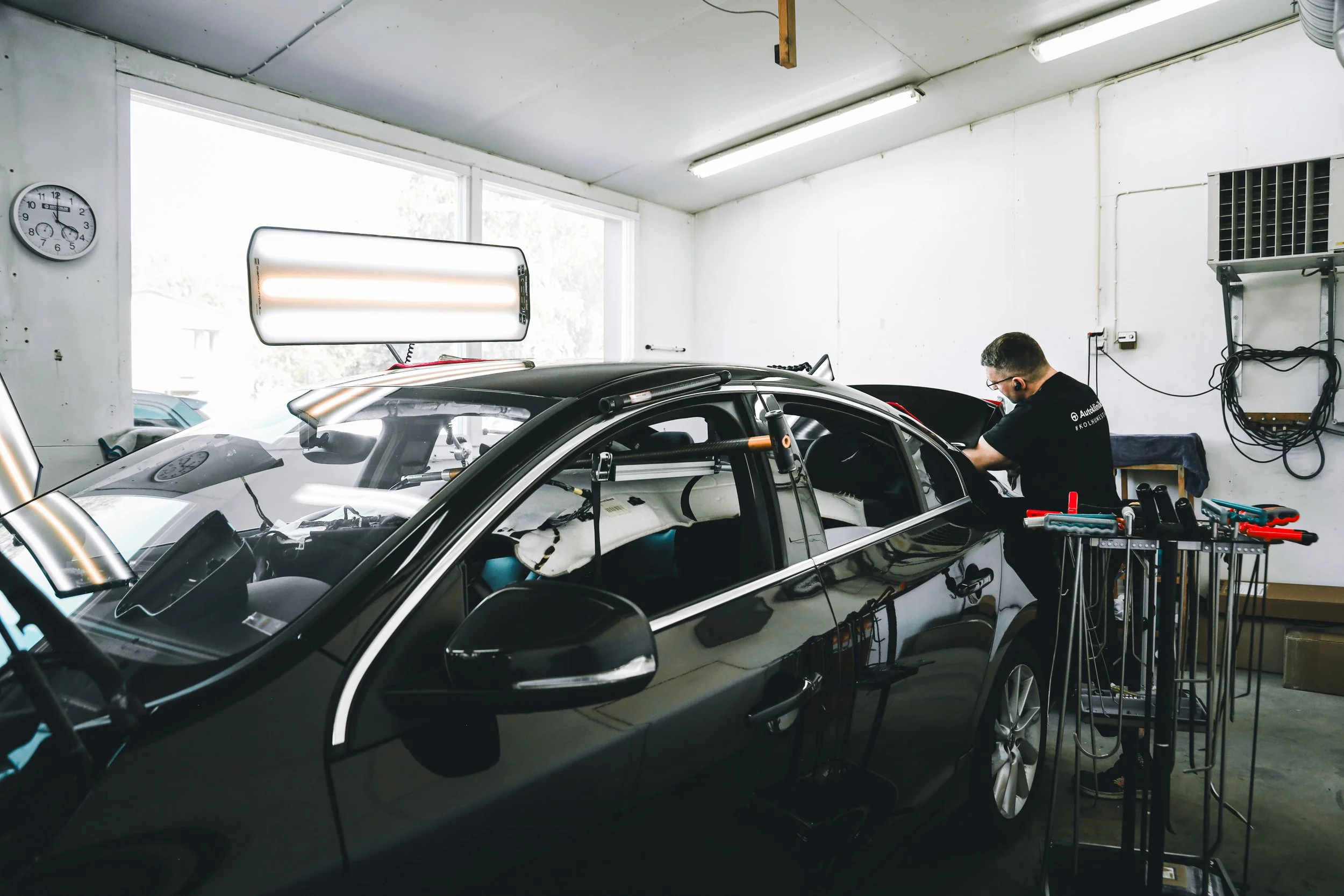Wide angle look of the PDR expert working on the car photographed by Annika TheVolvoGirl Miftakhova in Helsinki, Finland