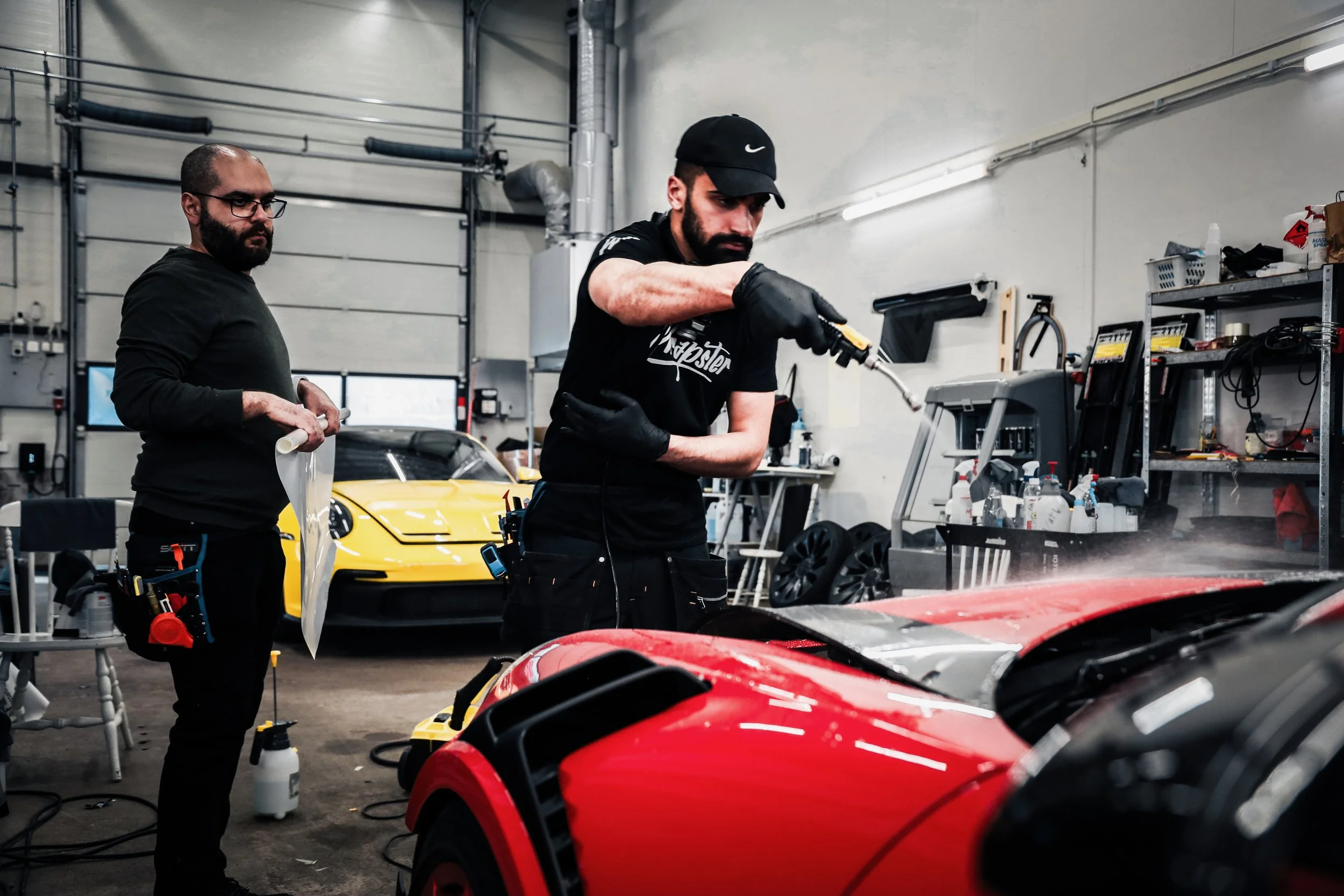 Wrapster Sweden installer waters the Red Porsche GT3 RS in Örebro, Sweden, photographed by Annika TheVolvoGirl Miftakhova.