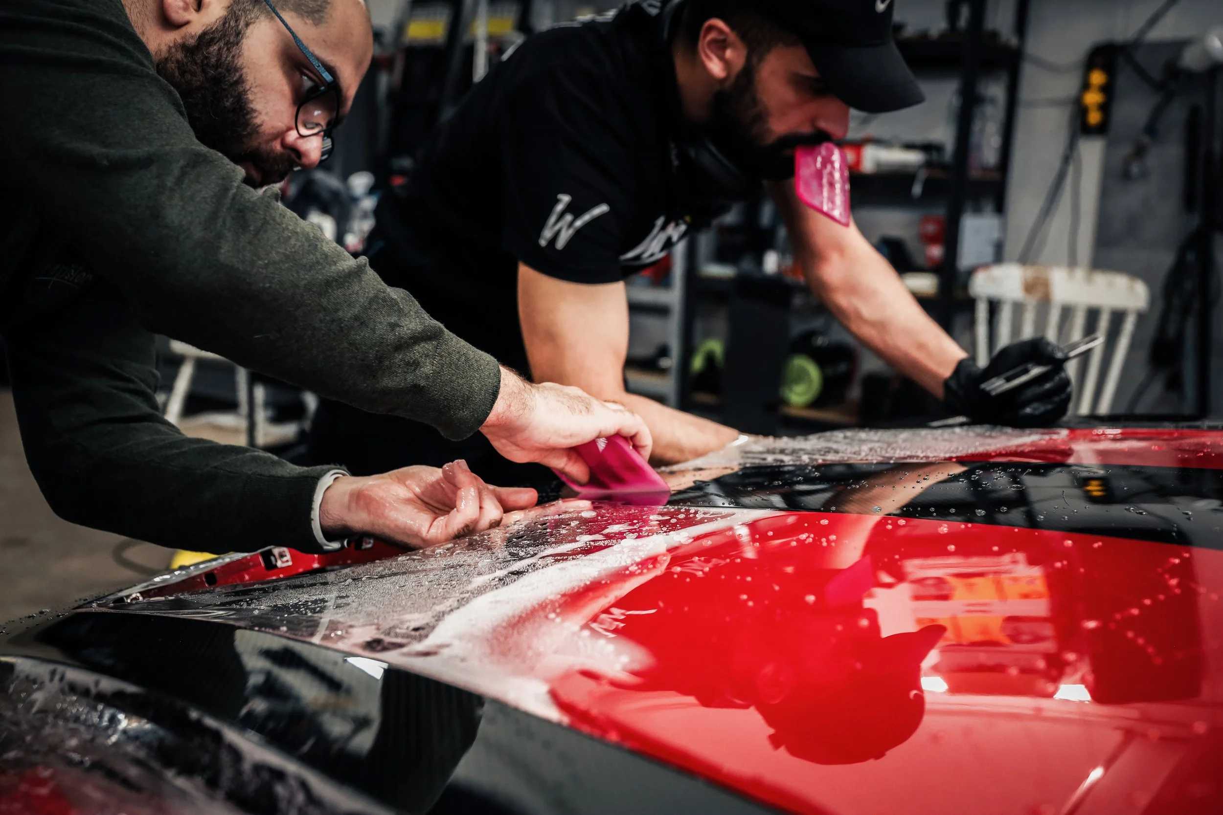 Wrapster workers install Paint Protection Film on the Red Porsche GT3 RS in Örebro, Sweden, photographed by Annika TheVolvoGirl Miftakhova.